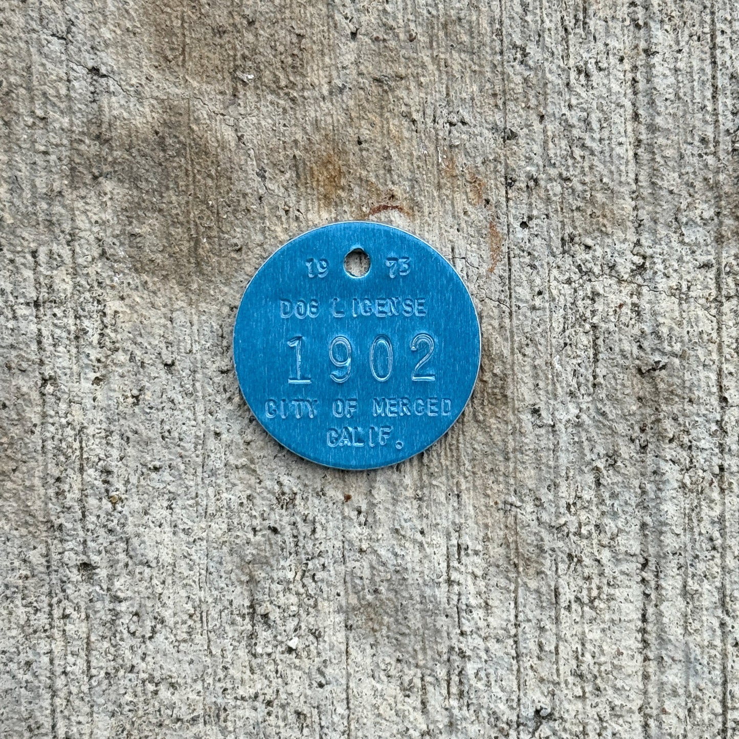 Photo of a 1973 California Dog License Auto Tag Garage Decor Vintage Merced 1902 with original patina