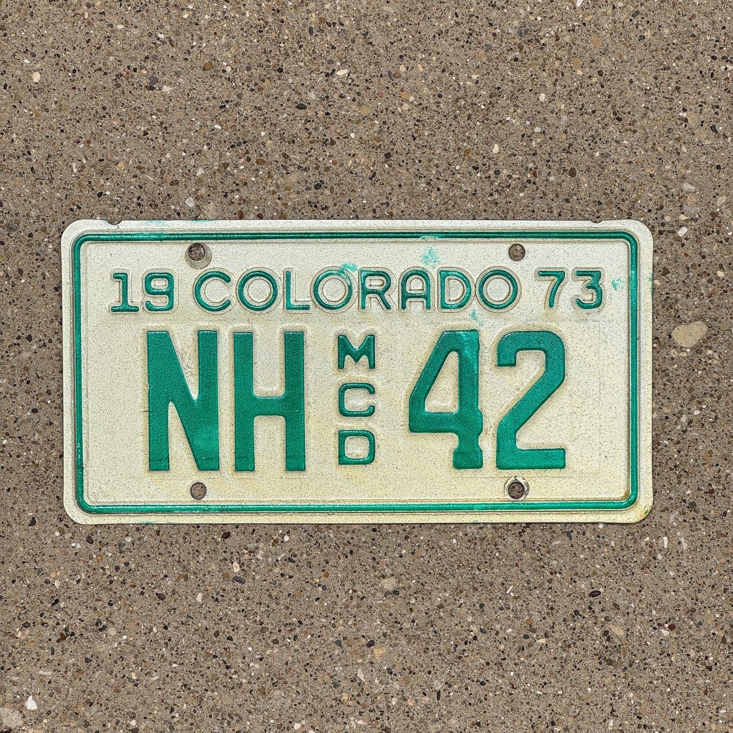 Photo of a 1973 Colorado Motorcycle Dealer License Plate Auto Tag Garage Decor Vintage NH 42