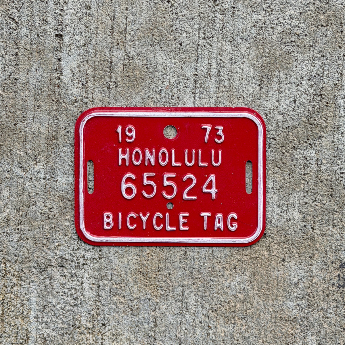 Photo of a 1973 Honolulu Hawaii Bicycle License Plate Auto Tag Garage Decor Vintage Bike 65524 with original patina