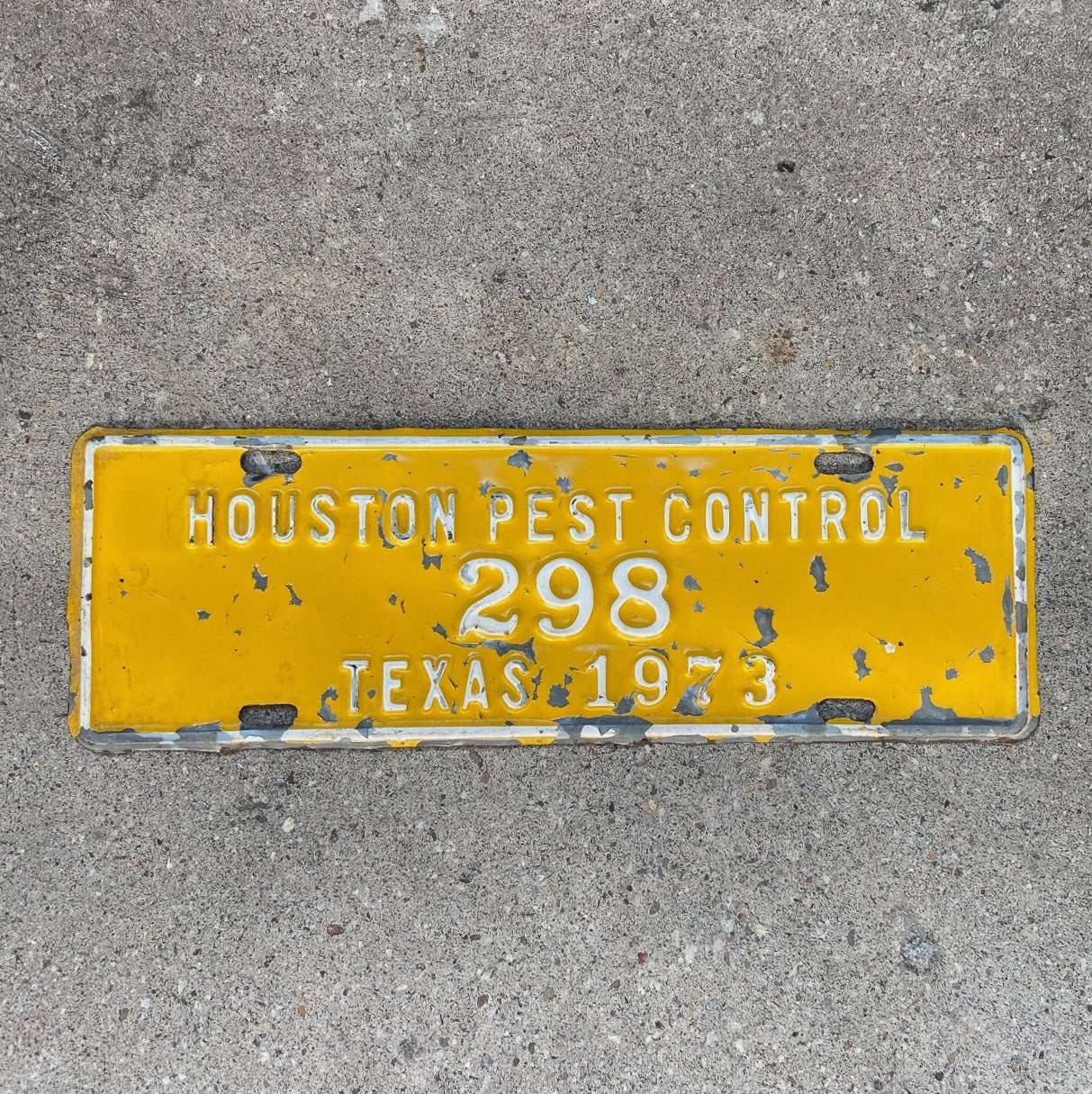 Photo of a 1973 Houston Texas License Plate Topper Auto Tag Garage Decor Vintage Pest Control Yellow Bugs Rodents 298 with original patina