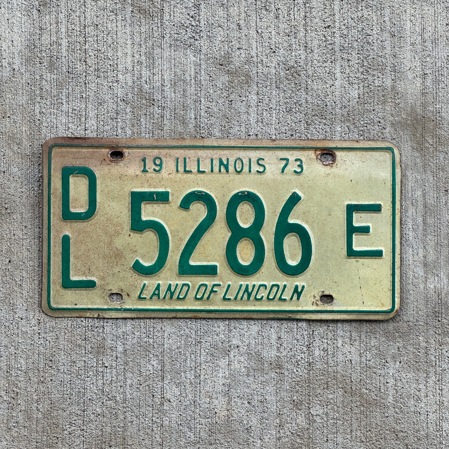 Photo of a 1973 Illinois Dealer License Plate Auto Tag 1 Vintage Garage 5286 E with original patina