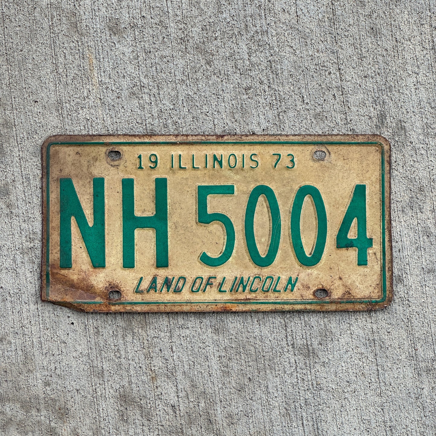 Photo of a 1973 Illinois License Plate Auto Tag 1 Vintage Garage NH 5004 with original patina