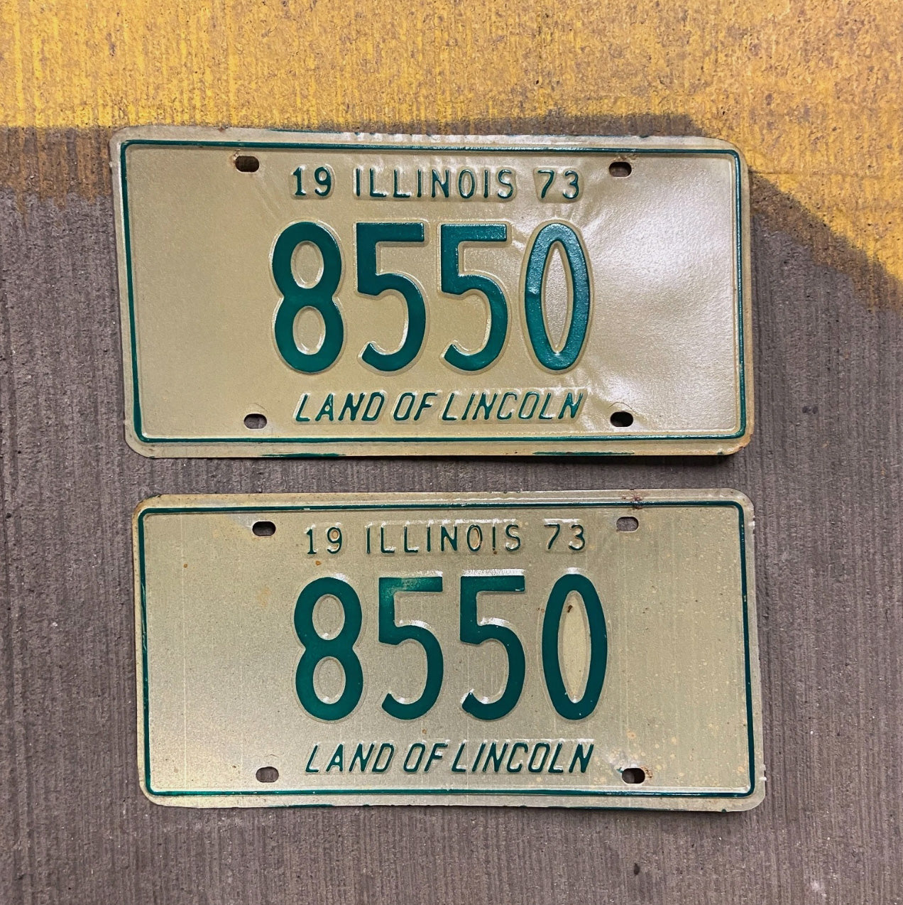 Photo of a 1973 Illinois License Plate Pair Auto Tag Garage Decor Vintage Low Number Four Digit 8550 with original patina