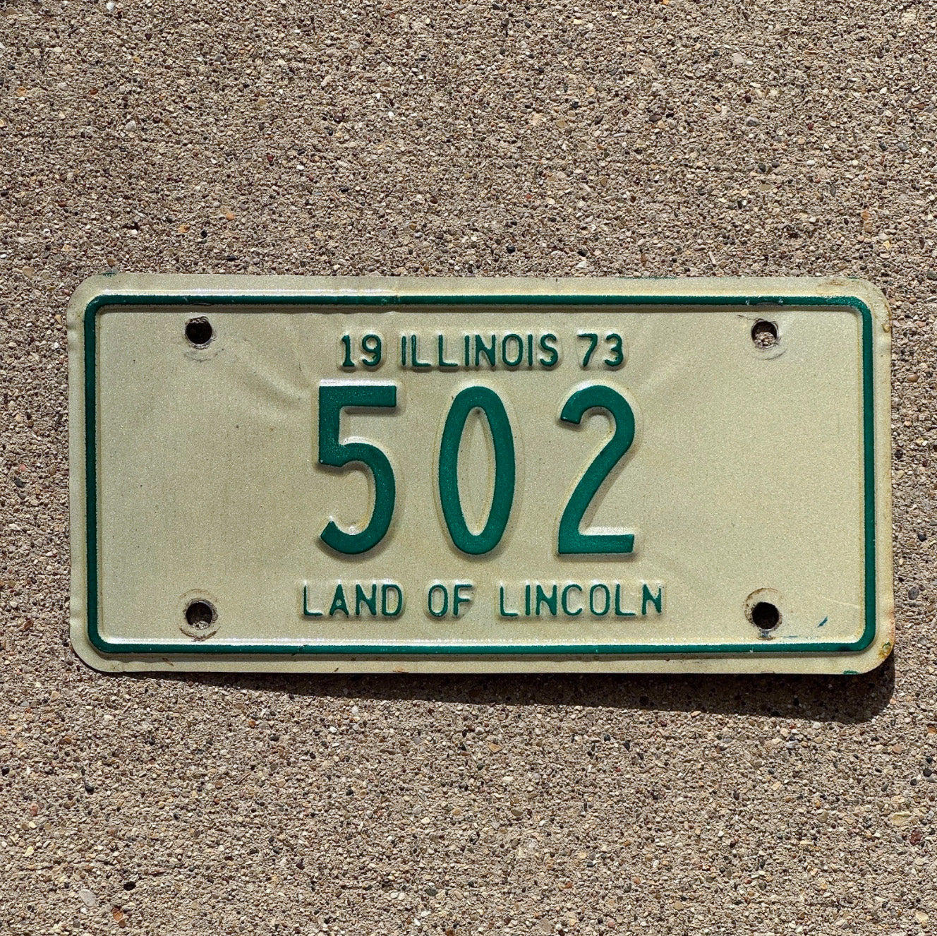 Photo of a 1973 Illinois Motorcycle License Plate Auto Tag Garage Decor Vintage Low Number Three Digit 502 with original patina