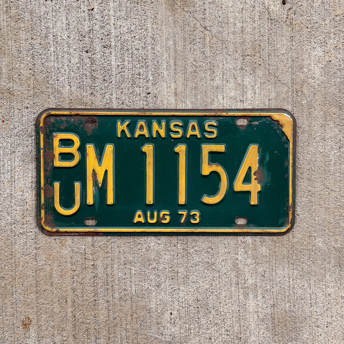 Photo of a 1973 Kansas License Plate Auto Tag Garage Decor Vintage BU M 1154 with original patina