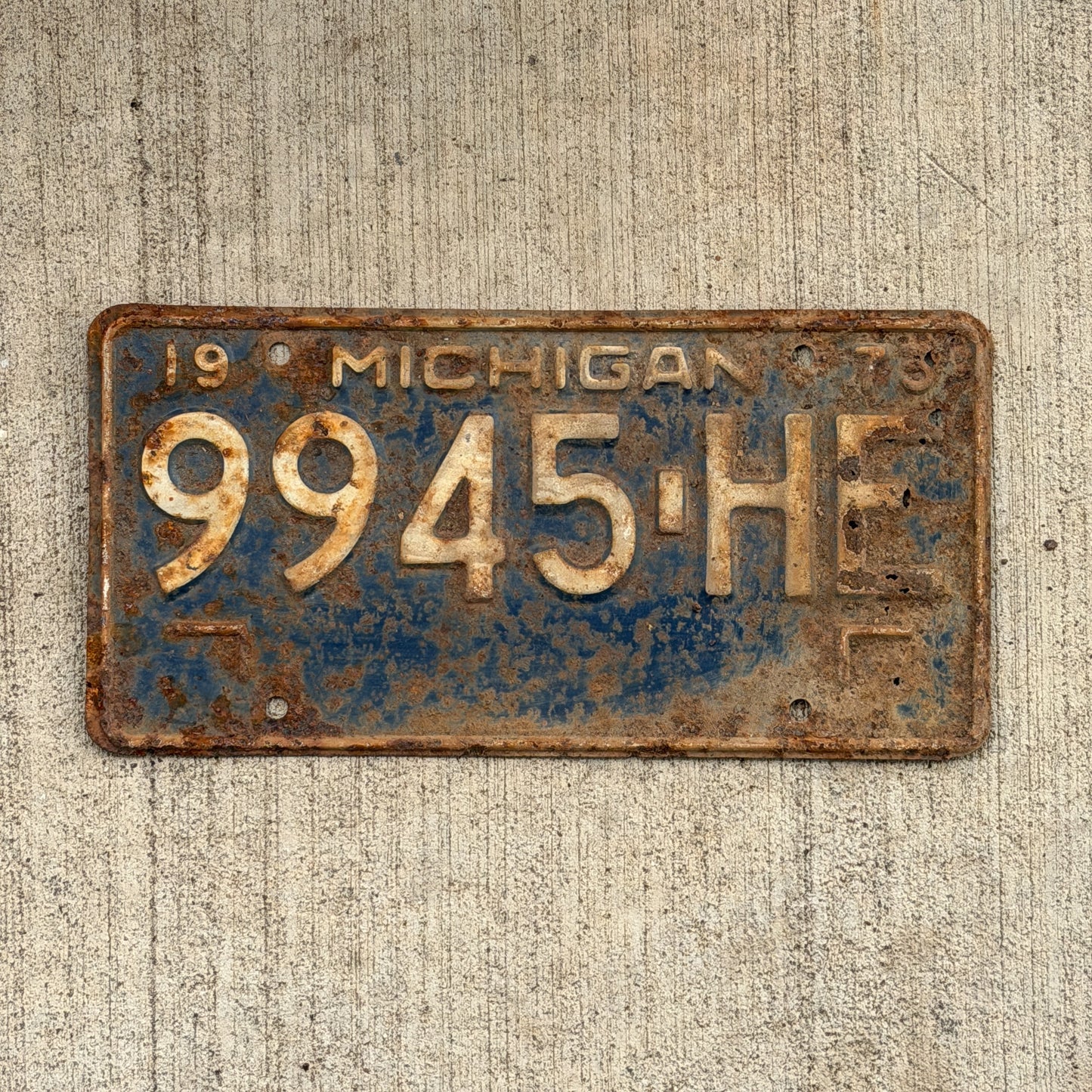 Photo of a 1973 Michigan Commercial License Plate Auto Tag Garage Decor Vintage 9945 HE with original patina