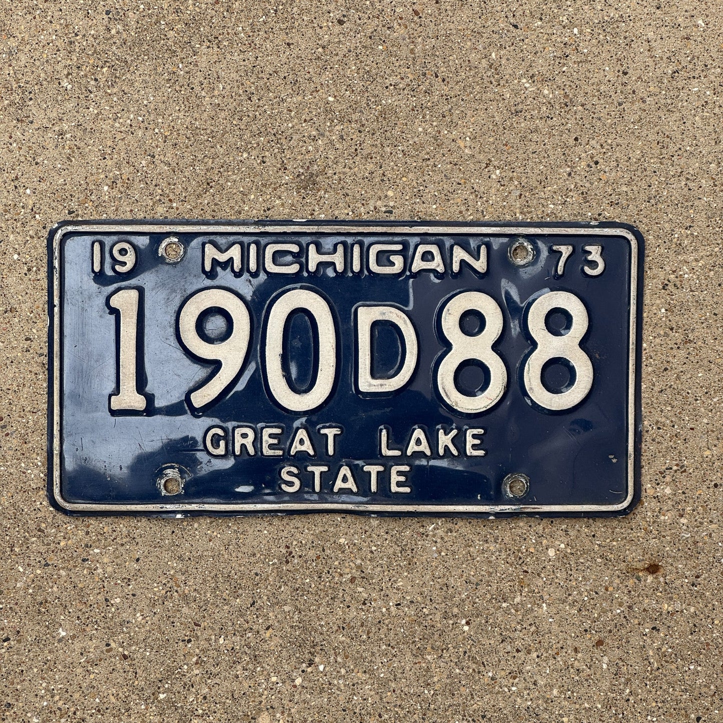 Photo of a 1973 Michigan Dealer License Plate Auto Tag Garage Decor Vintage 190 D 88