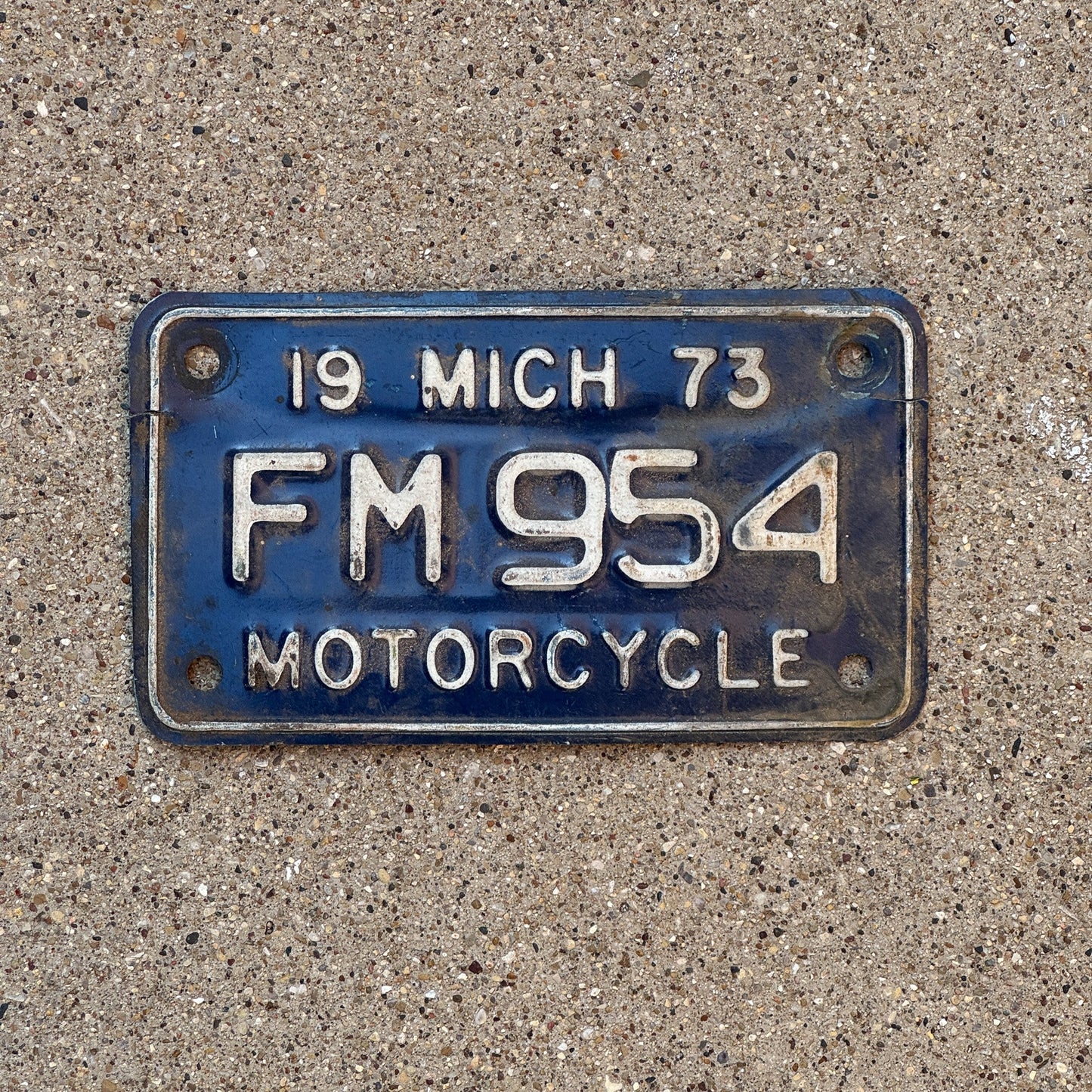 Photo of a 1973 Michigan Motorcycle License Plate Auto Tag Garage Decor Vintage FM 954