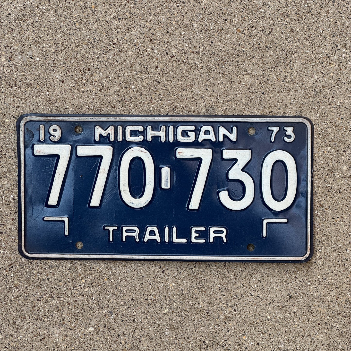 Photo of a 1973 Michigan Trailer License Plate Auto Tag Garage Decor Vintage 770 730