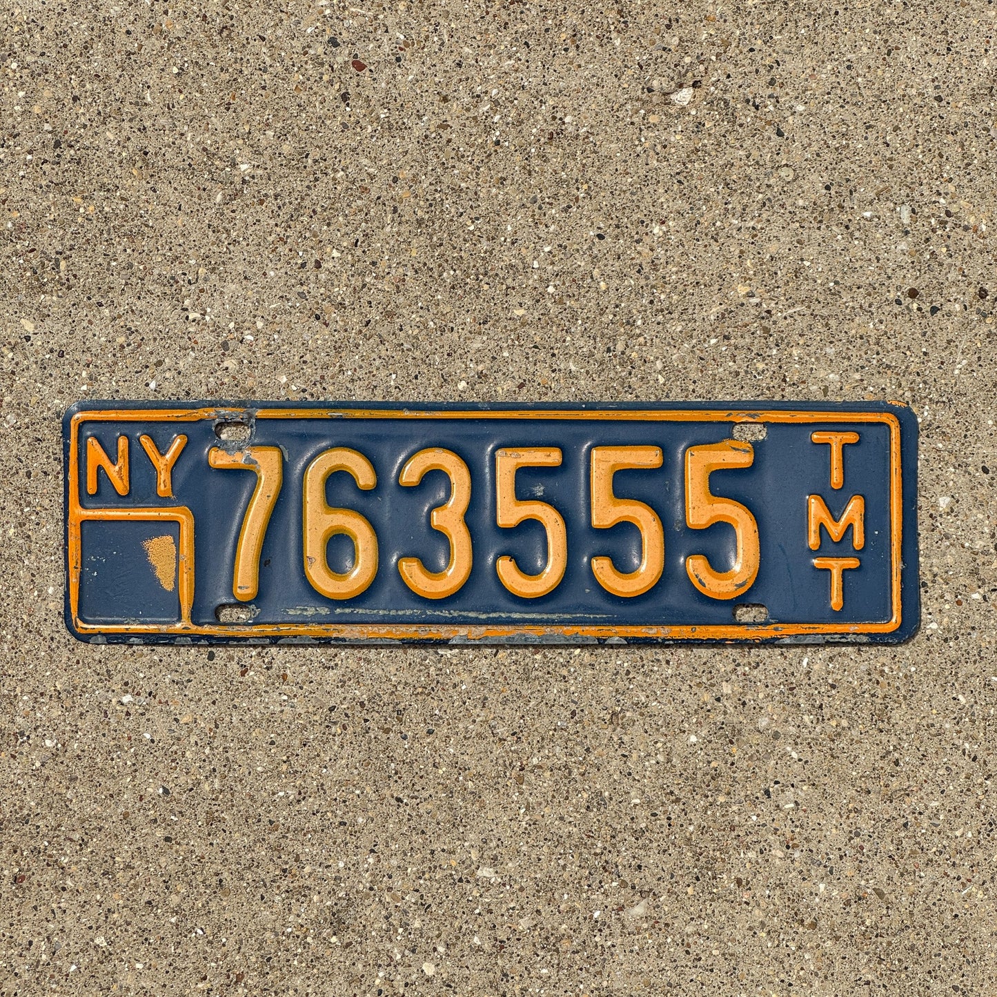 Photo of a 1973 New York Truck Mile Tax License Plate Auto Tag Garage Decor Vintage Series 8 763 555