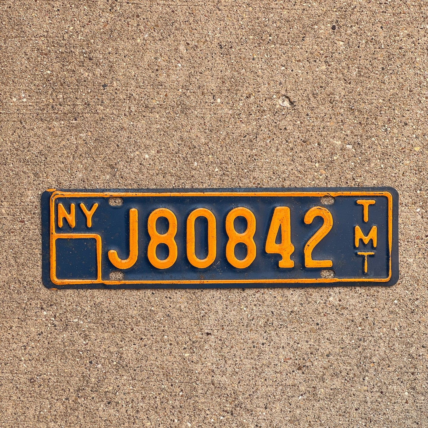 Photo of a 1973 New York Truck Mile Tax License Plate Auto Tag Garage Decor Vintage Series 8 J 80842 TMT