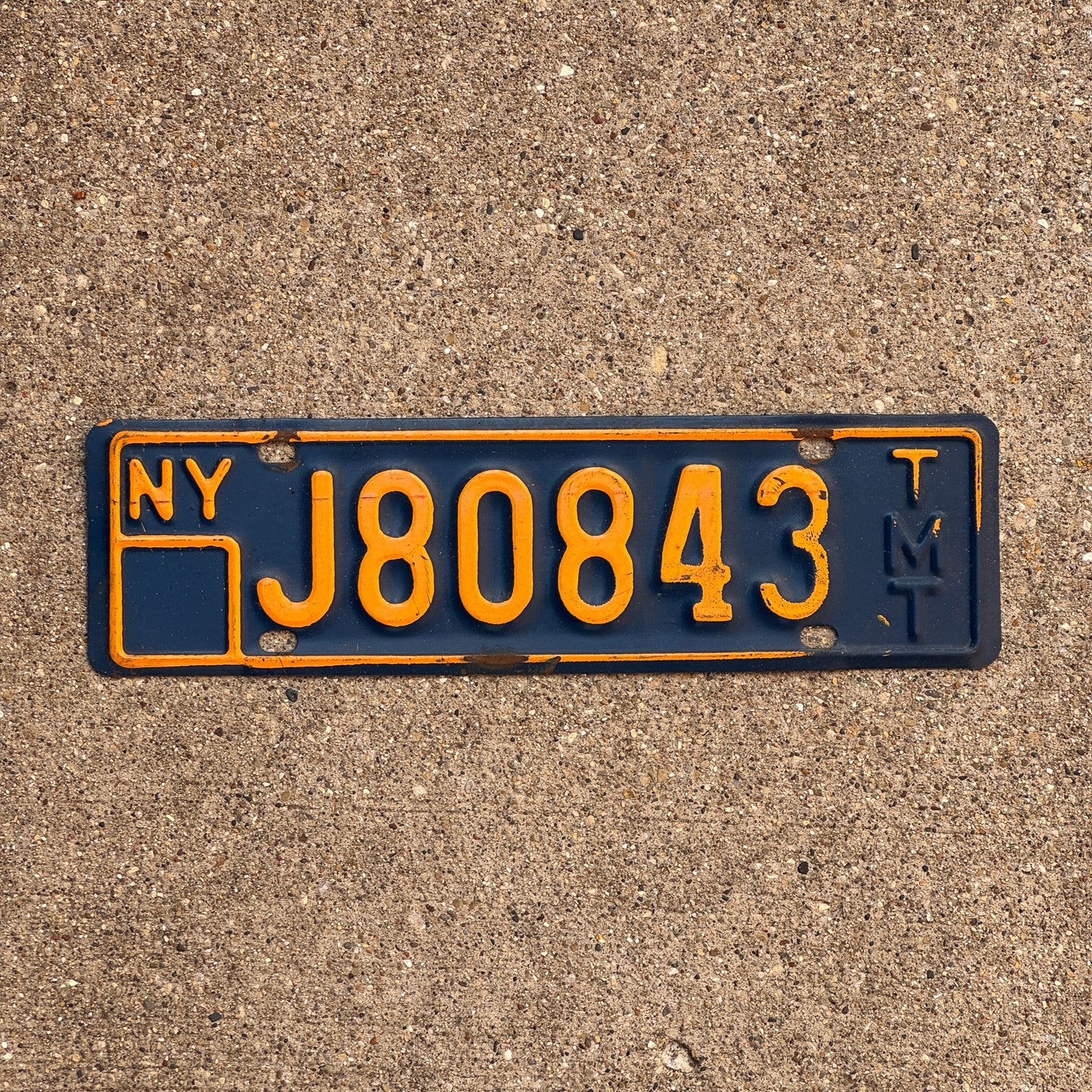 Photo of a 1973 New York Truck Mile Tax License Plate Auto Tag Garage Decor Vintage Series 8 J 80843 TMT