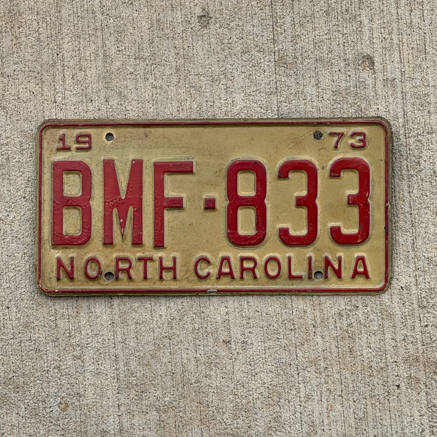 Photo of a 1973 North Carolina License Plate Auto Tag Garage Decor Vintage BMF 833 with original patina