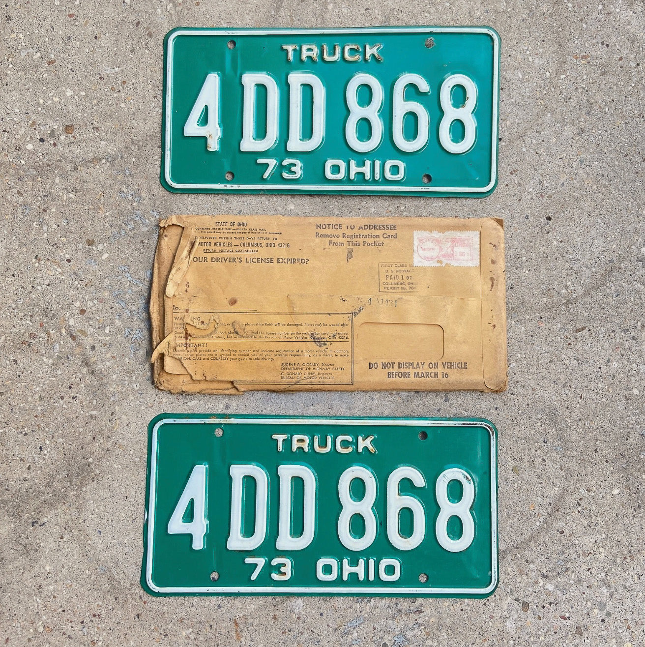 Photo of a 1973 Ohio Truck License Plate Pair Auto Tag Garage Decor Vintage With Non-Matching Envelope 4 DD 868 with original patina