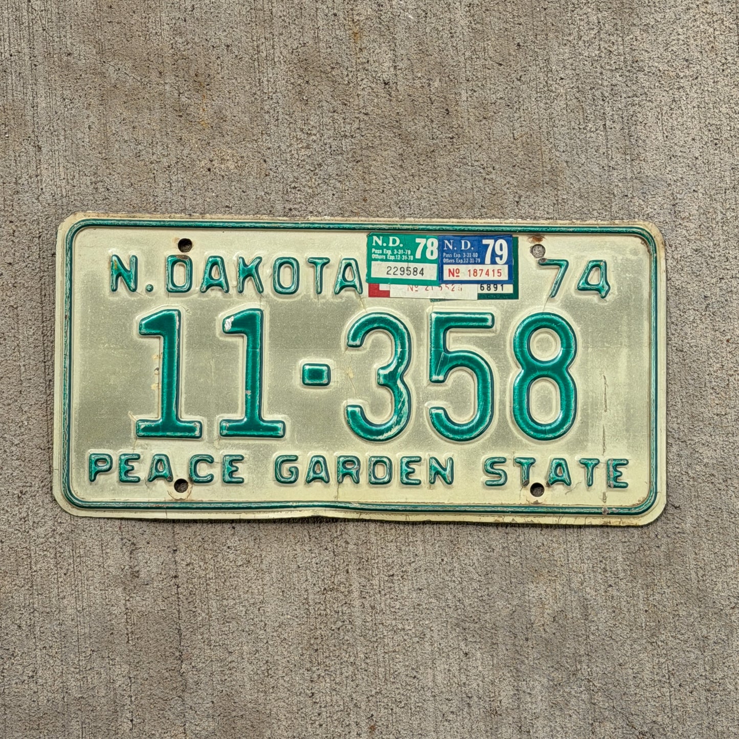 Photo of a 1974 1979 North Dakota License Plate Auto Tag Garage Decor Vintage 11 358 with original patina
