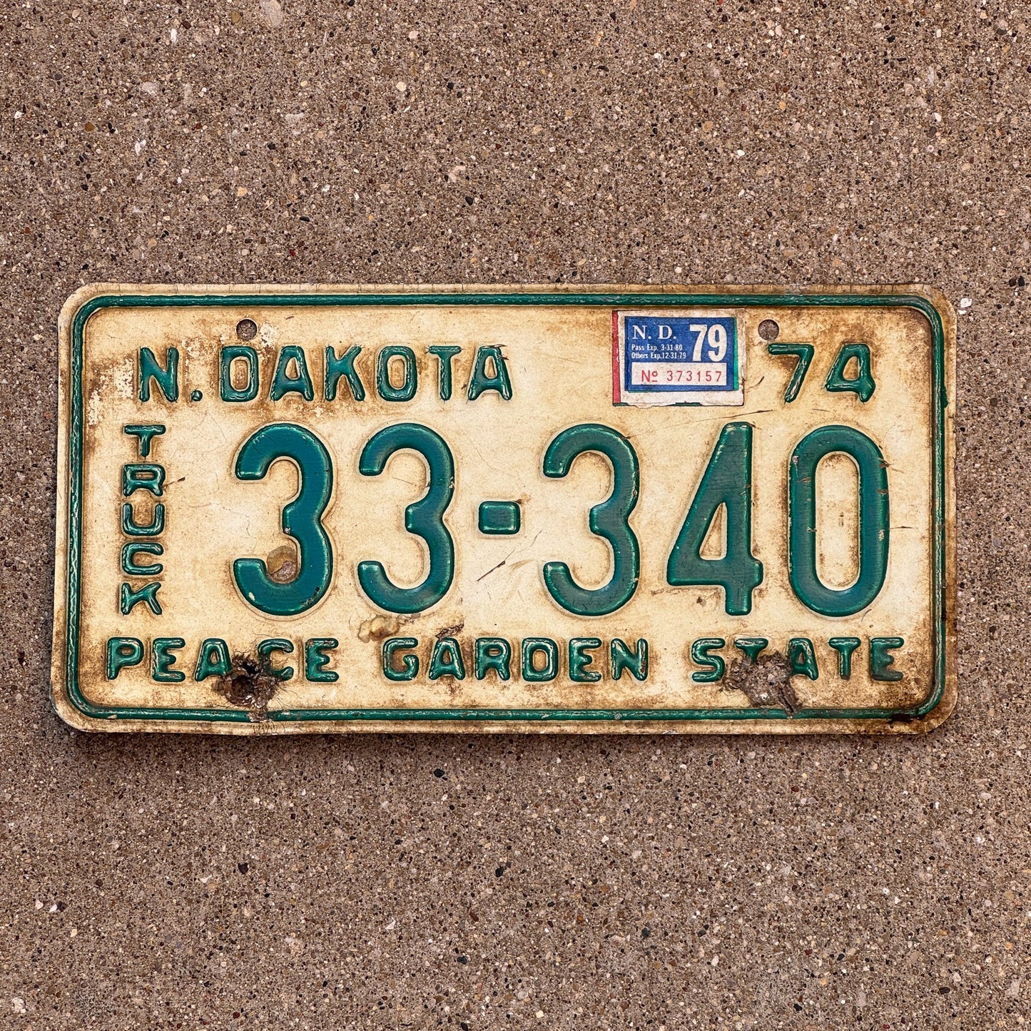 Photo of a 1974 1979 North Dakota Truck License Plate Auto Tag Garage Decor Vintage 33 340 with original patina