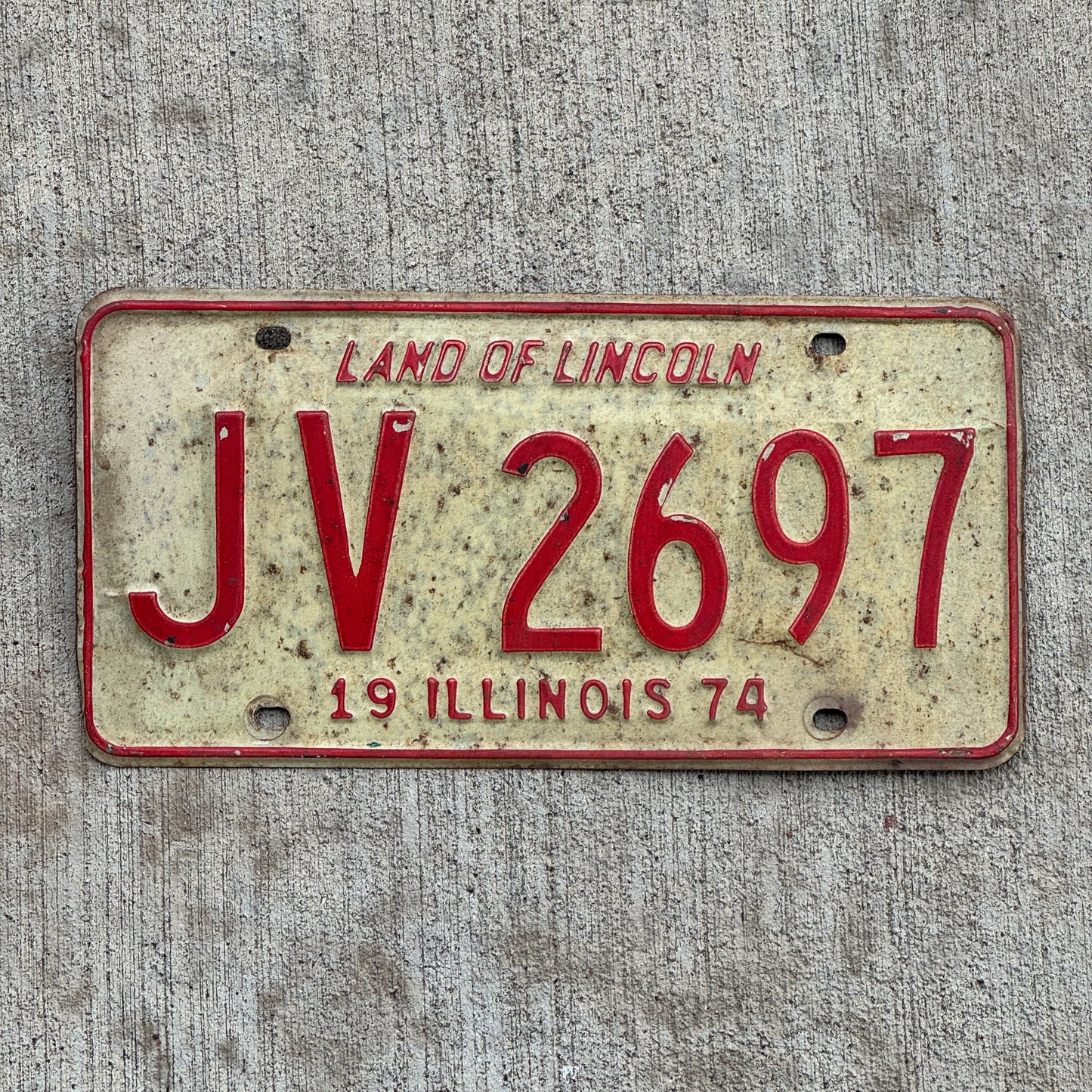 Photo of a 1974 Illinois License Plate Auto Tag 2 Vintage Garage JV 2697 with original patina