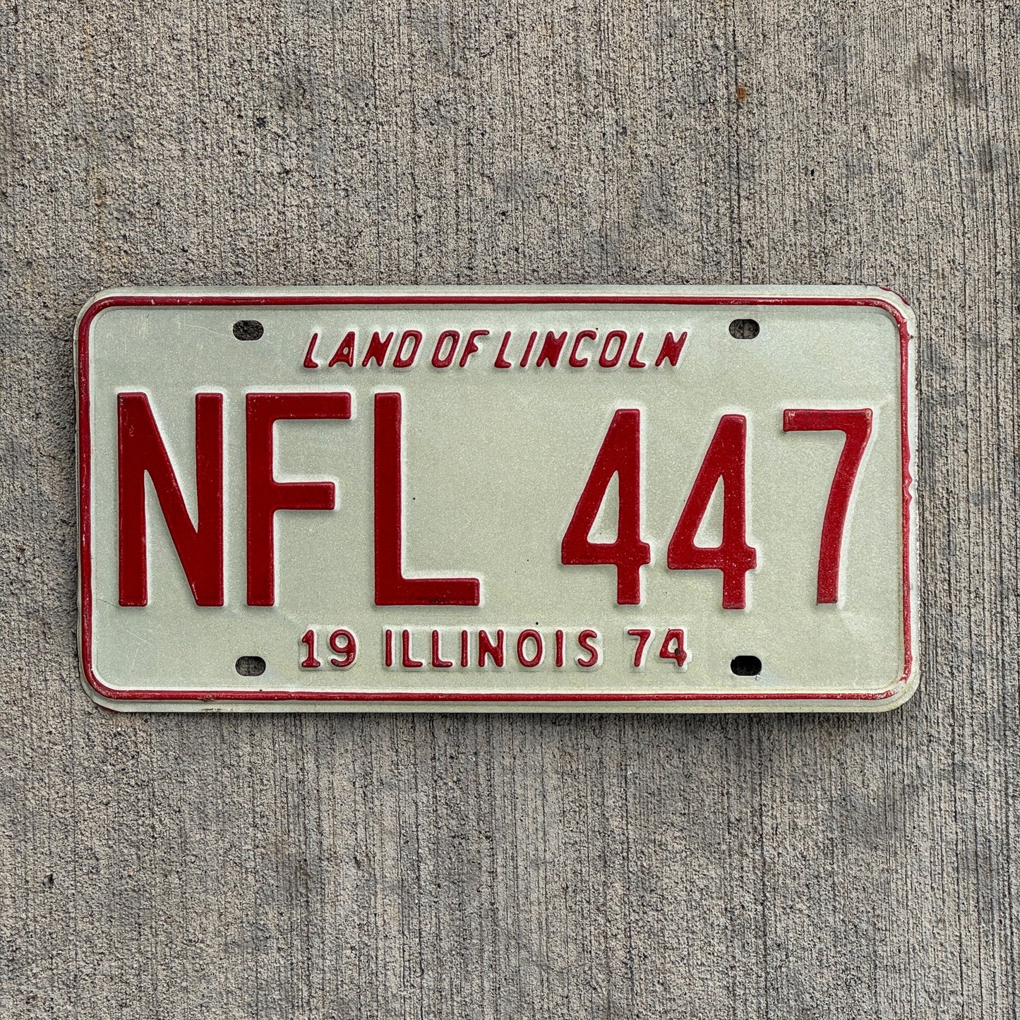 Photo of a 1974 Illinois License Plate Auto Tag Garage Decor Vintage Football League Sports Related NFL 447 with original patina