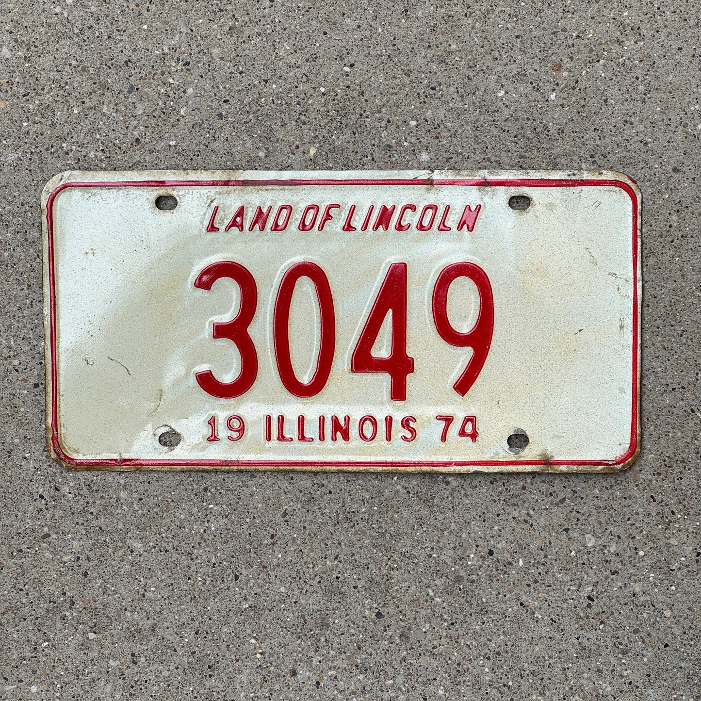 Photo of a 1974 Illinois License Plate Auto Tag Garage Decor Vintage Low Number Four Digit 3049 with original patina