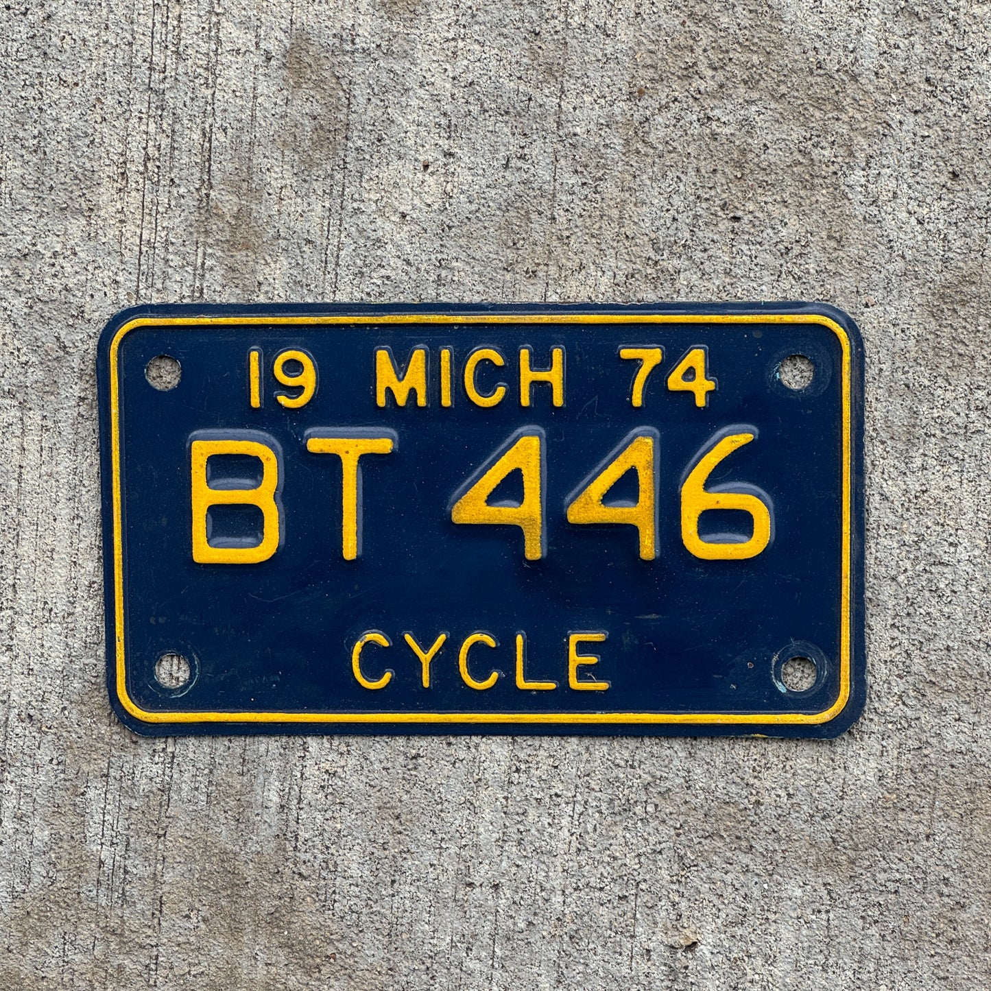 Photo of a 1974 Michigan Motorcycle License Plate Auto Tag Garage Decor Vintage BT 446 with original patina