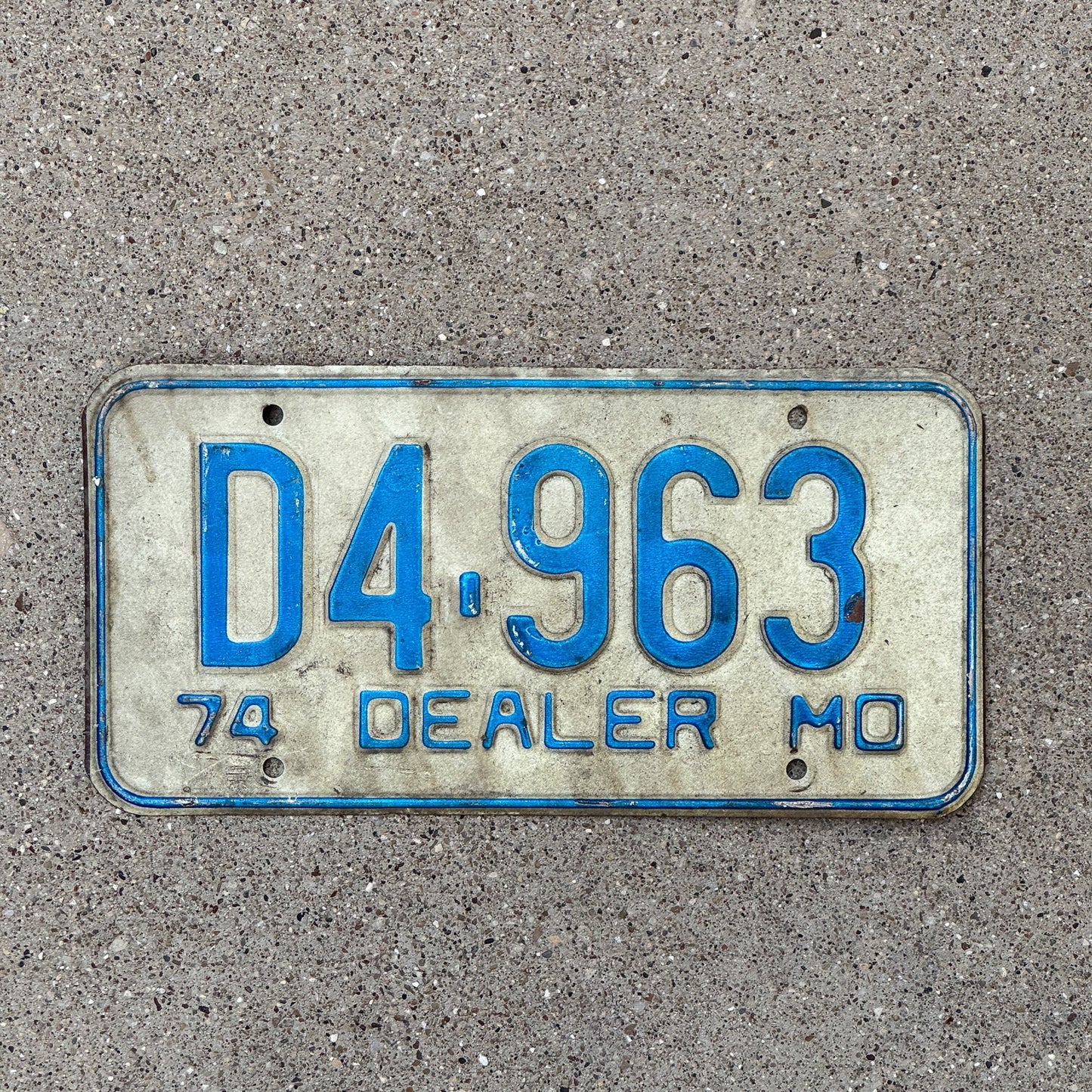 Photo of a 1974 Missouri Dealer License Plate Auto Tag Garage Decor Vintage D 4963