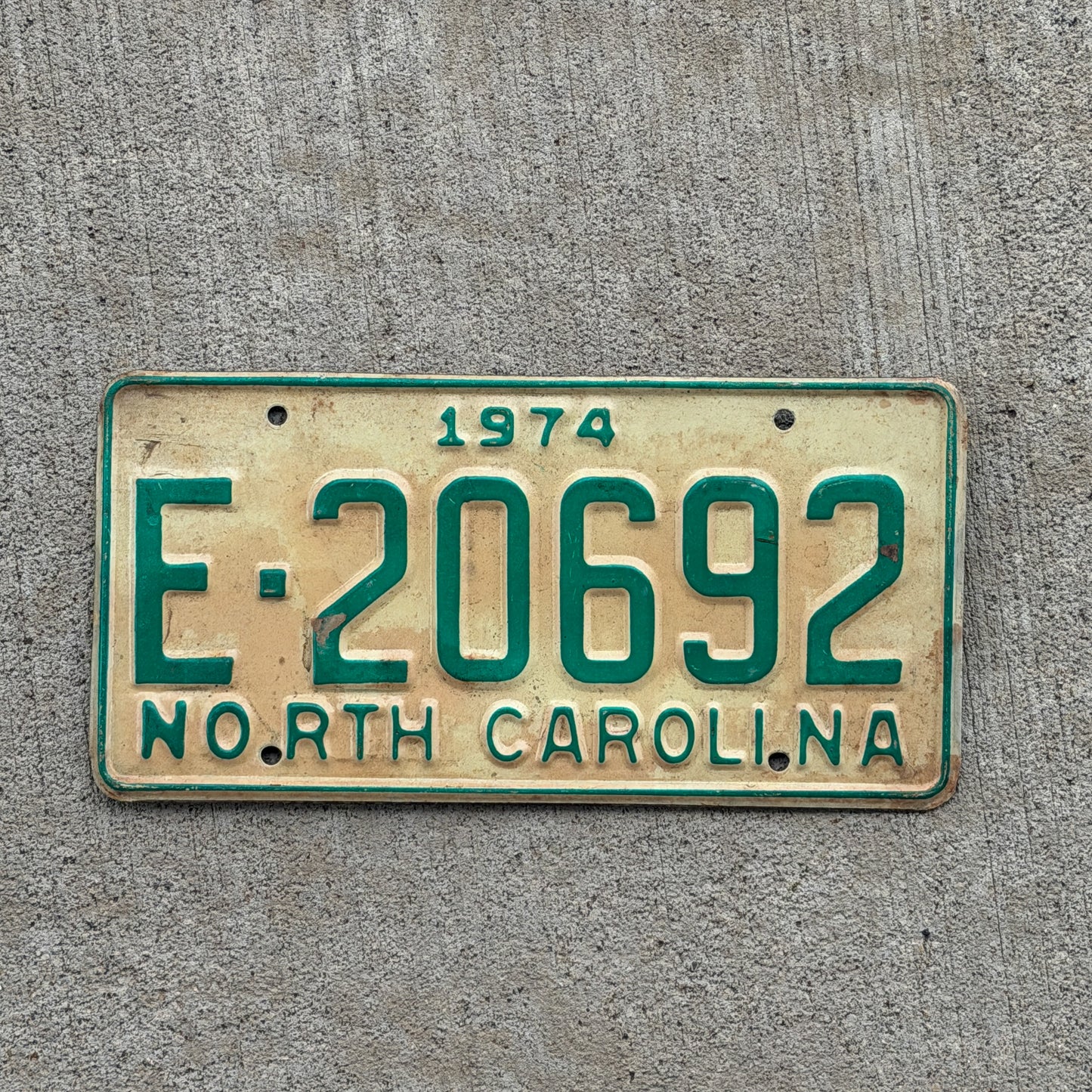Photo of a 1974 North Carolina Trailer License Plate Auto Tag Garage Decor Vintage Private Trailer E 20692 with original patina