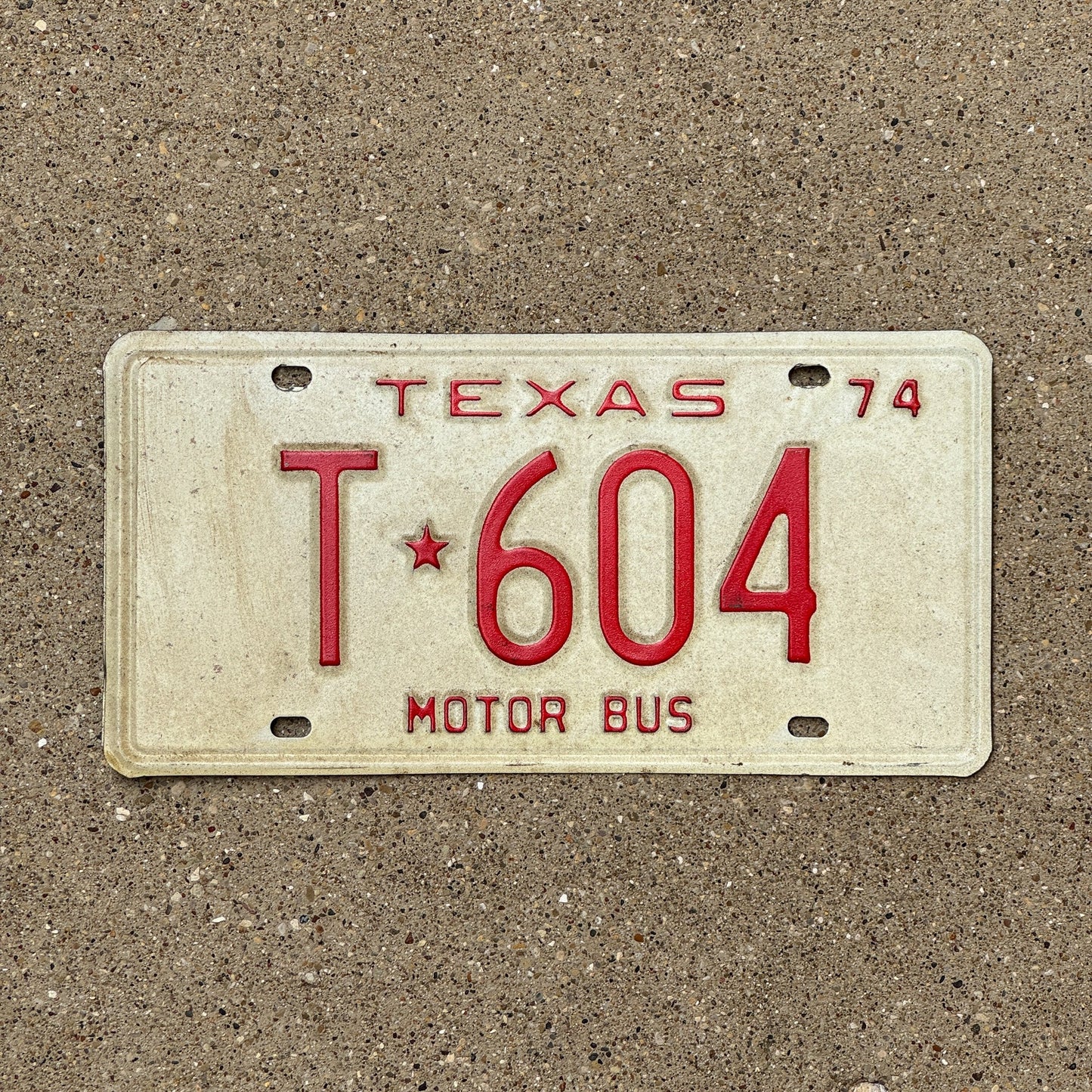 Photo of a 1974 Texas Motor Bus License Plate Auto Tag Garage Decor Vintage T 604