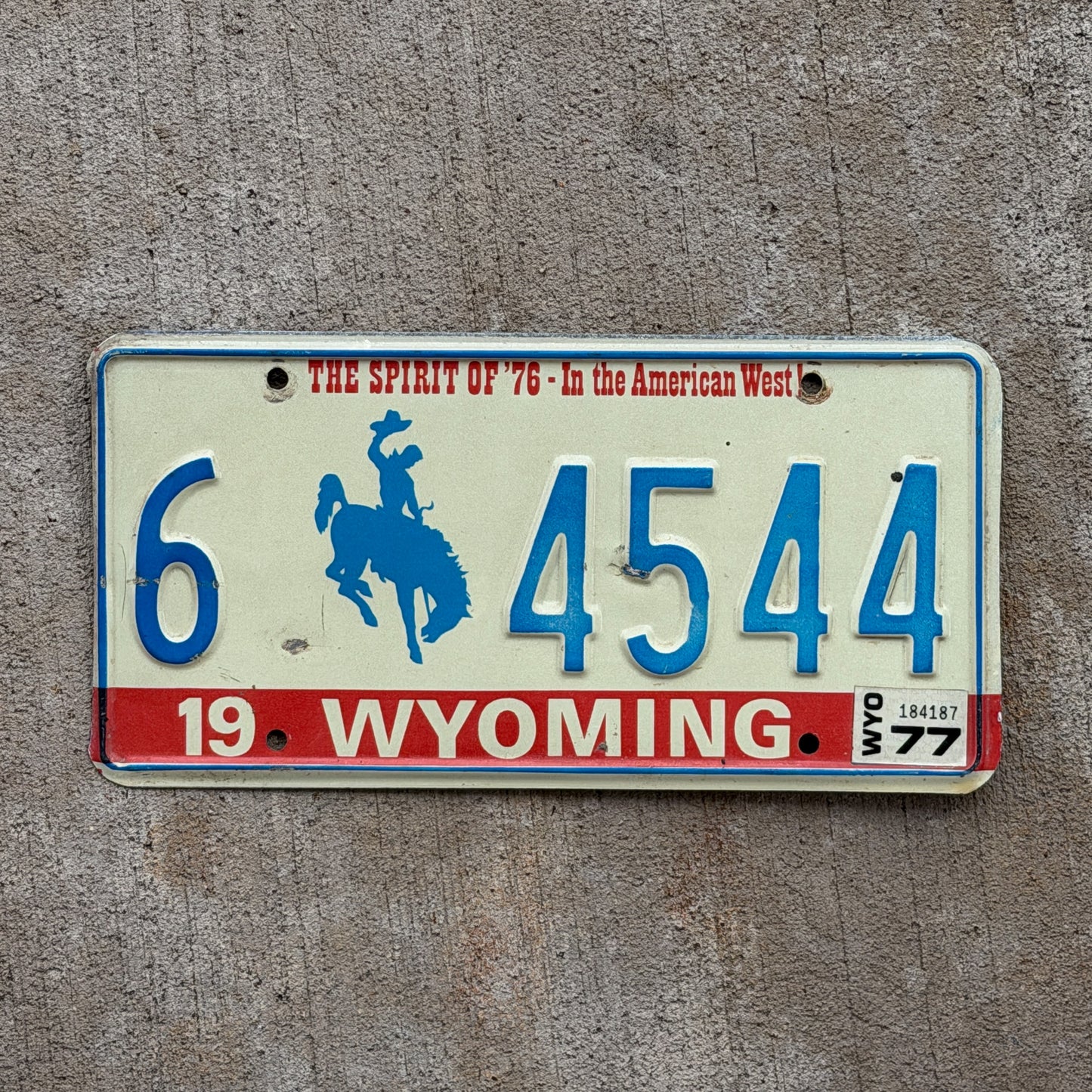 Photo of a 1975 1977 Wyoming License Plate Auto Tag 1 Vintage Garage Bicentennial Cowboy Rodeo 6 4544 with original patina