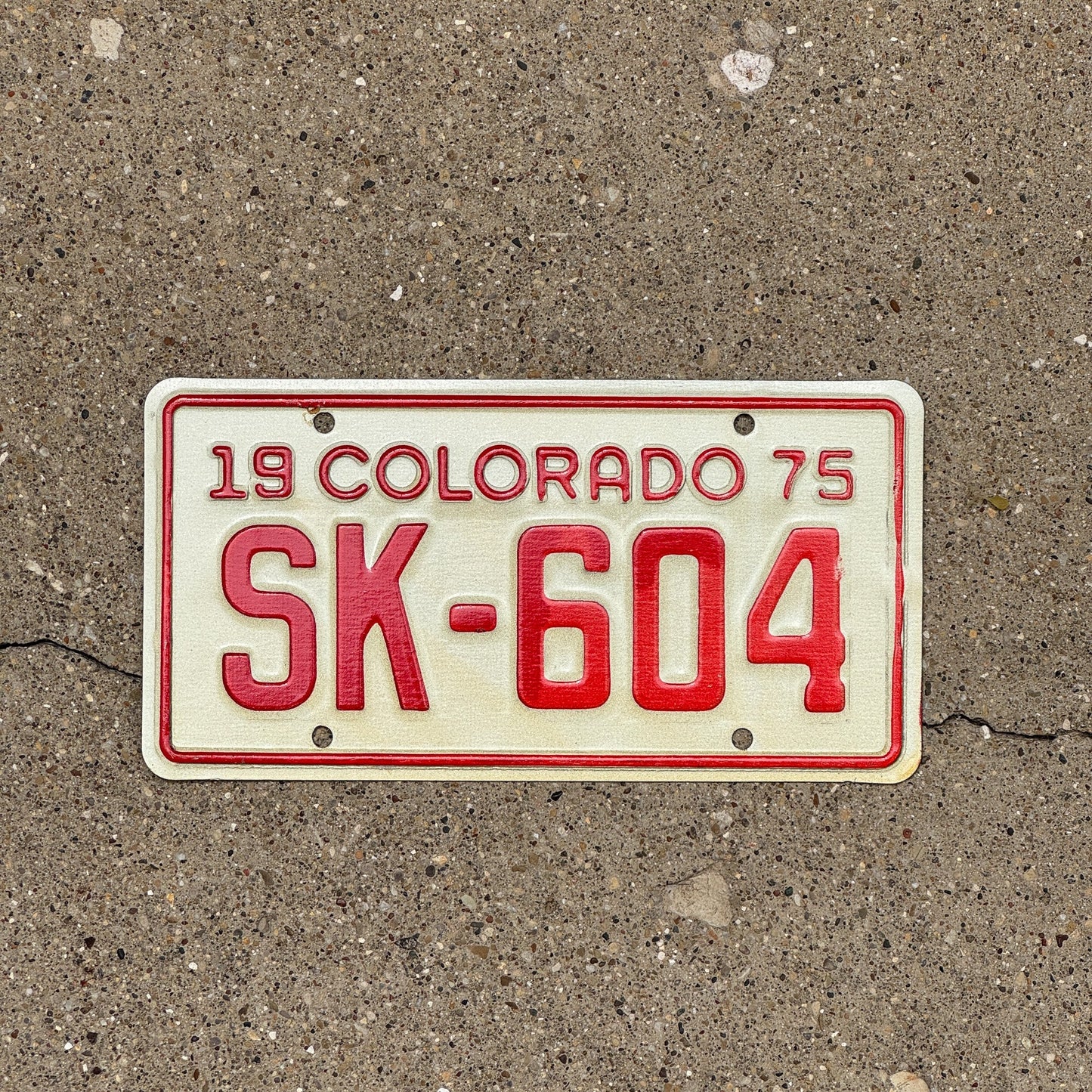 Photo of a 1975 Colorado Motorcycle License Plate Auto Tag Garage Decor Vintage SK 604