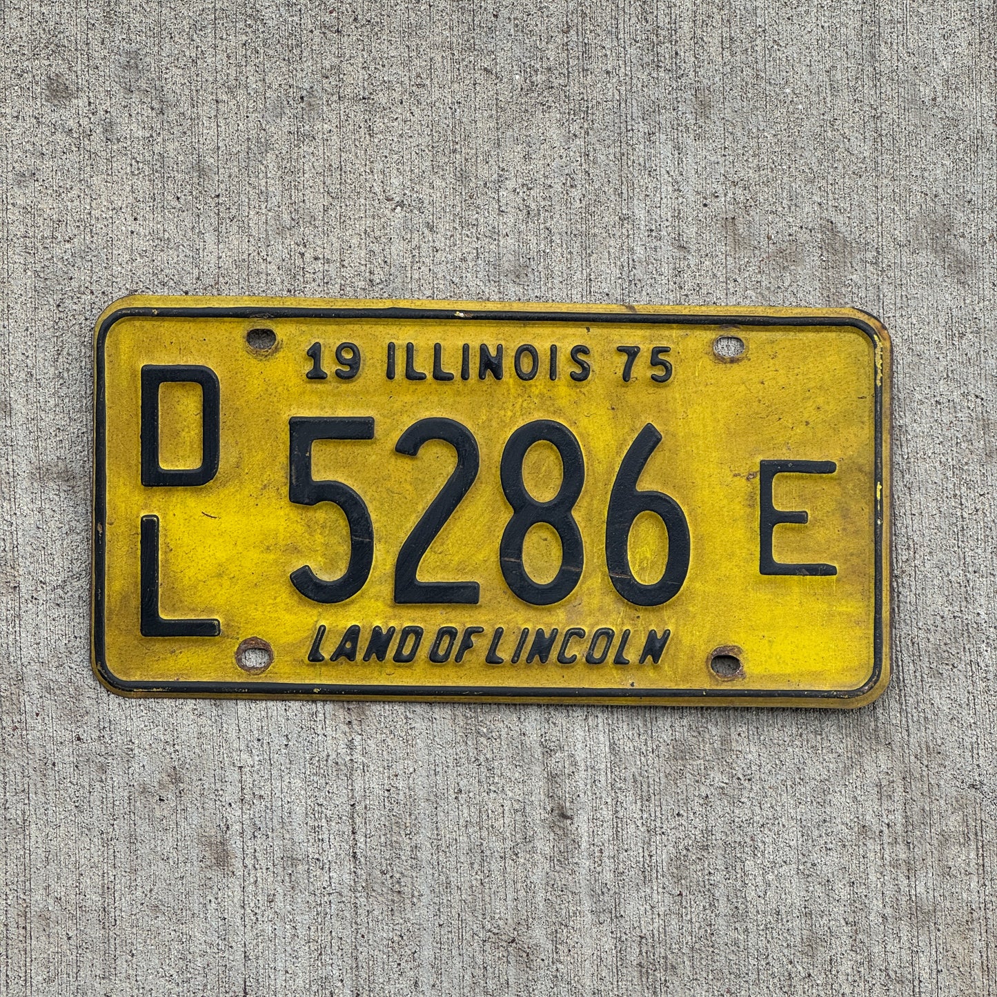 Photo of a 1975 Illinois Dealer License Plate Auto Tag 1 Vintage Garage 5286 E with original patina