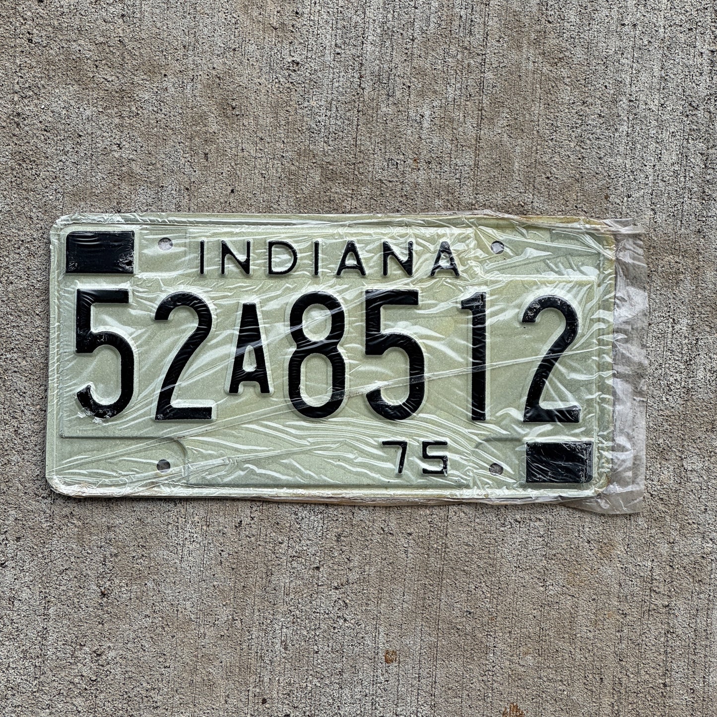 Photo of a 1975 Indiana License Plate Auto Tag Garage Decor Vintage New Old Stock 52 A 8512 with original patina