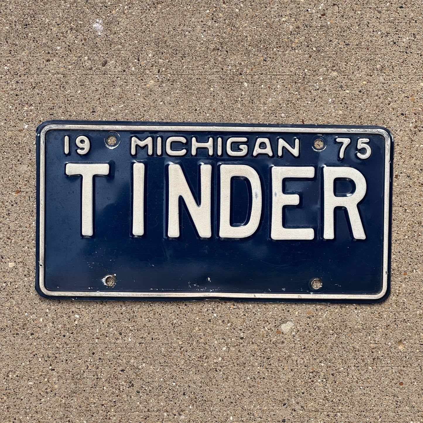 Photo of a 1975 Michigan Vanity License Plate Auto Tag Garage Decor Vintage Dating App Fire Camping TINDER