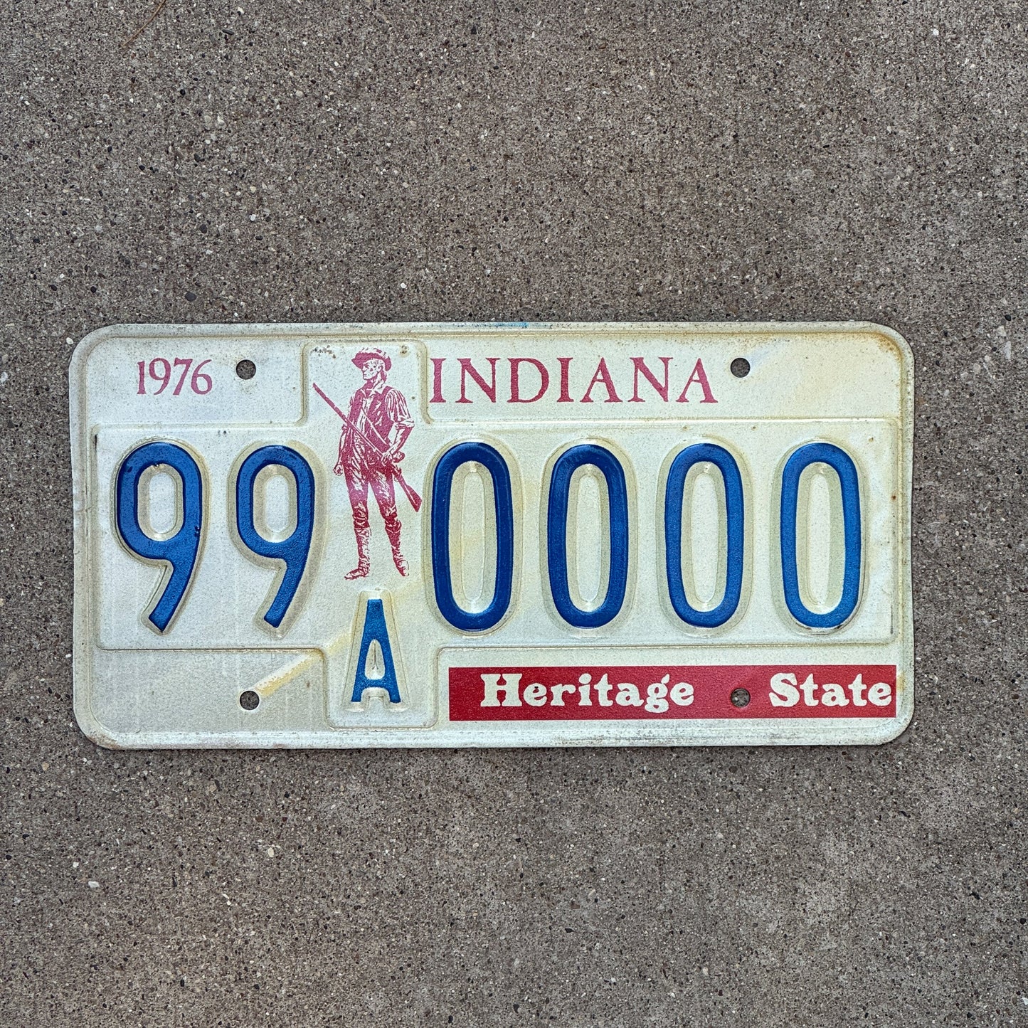Photo of a 1976 1977 Indiana Sample License Plate Auto Tag 4 Vintage 99A0000 with original patina