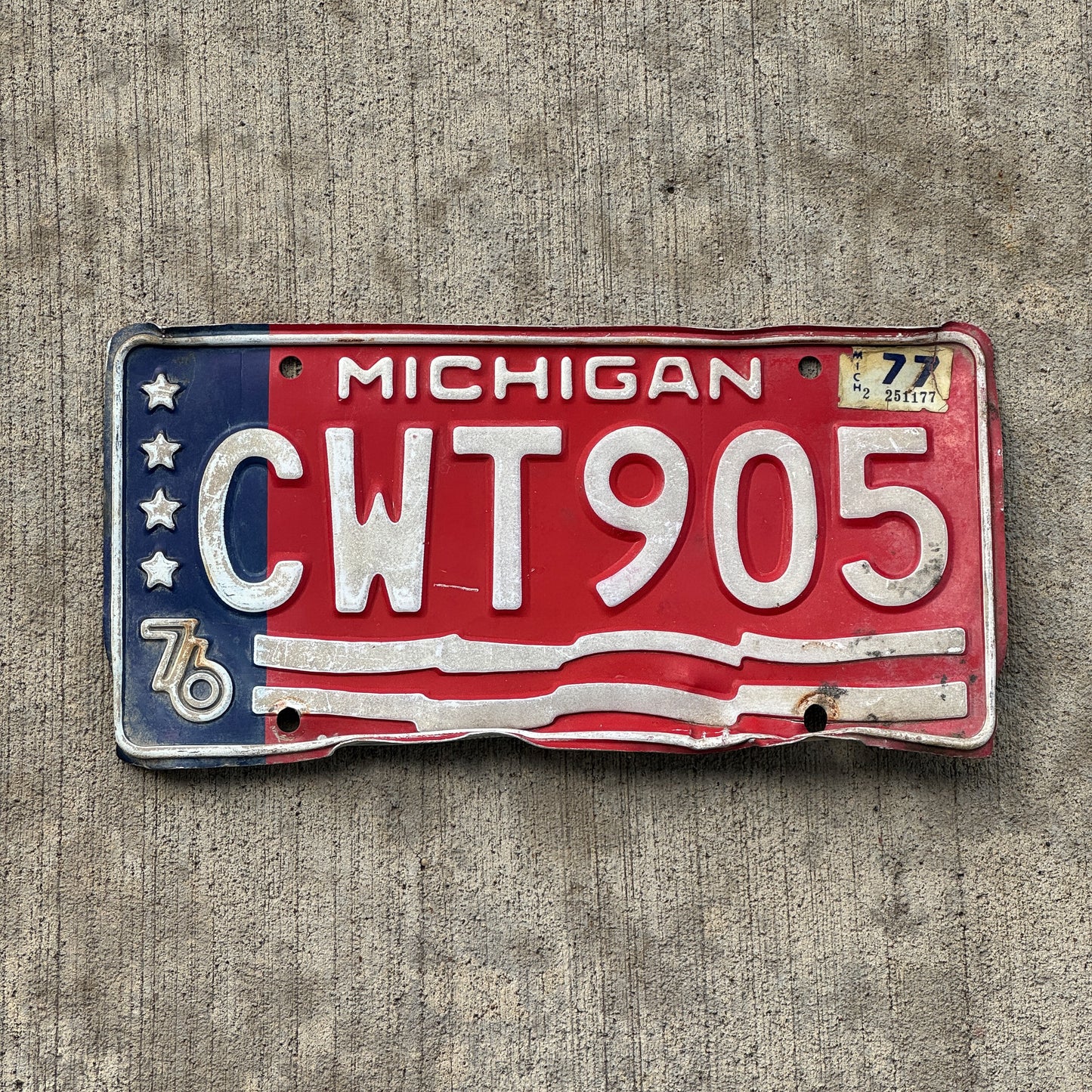 Photo of a 1976 1977 Michigan License Plate Auto Tag Garage Decor Vintage American Flag Bicentennial CWT 905 with original patina
