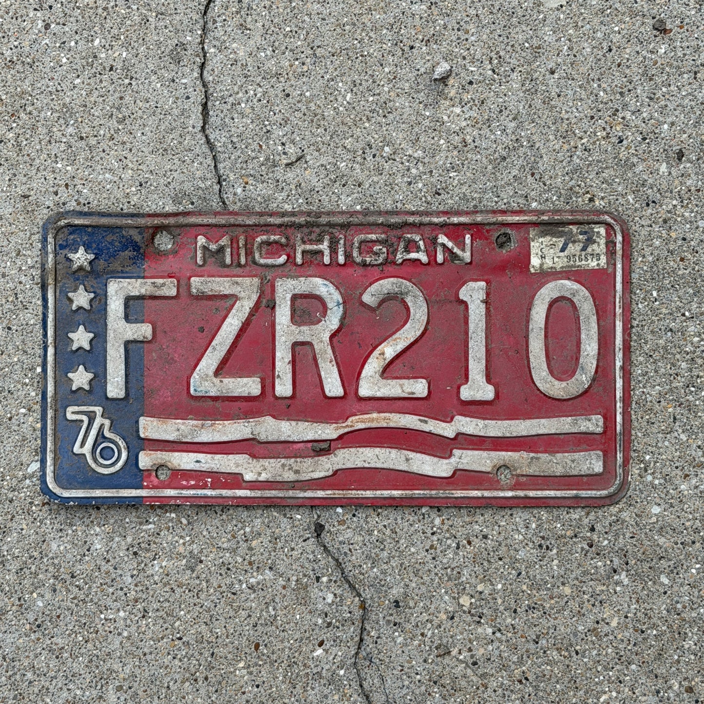 Photo of a 1976 1977 Michigan License Plate Auto Tag Garage Decor Vintage Bicentennial FZR 210 with original patina