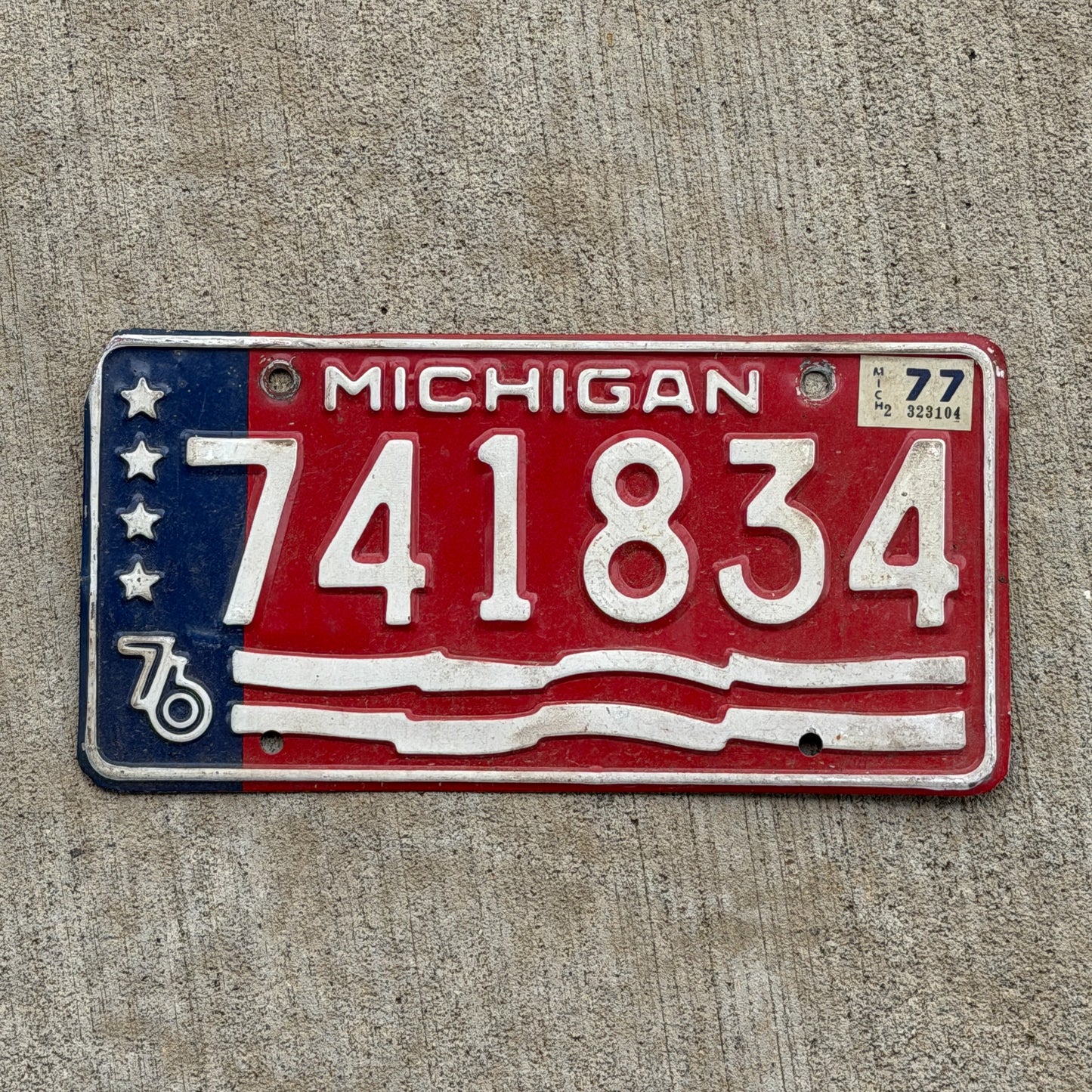 Photo of a 1976 1977 Michigan Trailer License Plate Auto Tag Garage Decor Vintage Bicentennial 741 834 with original patina
