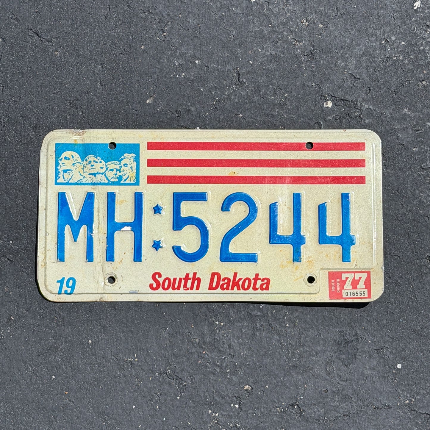 Photo of a 1976 1977 South Dakota License Plate Auto Tag 1 Vintage Garage MH 5244 with original patina