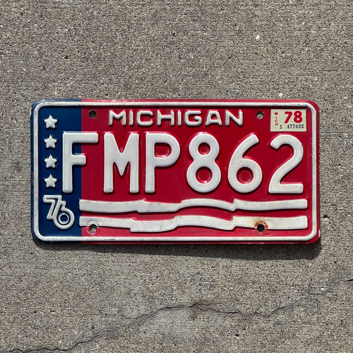 Photo of a 1976 1978 Michigan License Plate Auto Tag 2 Vintage Garage American Flag Bicentennial FMP 862 with original patina