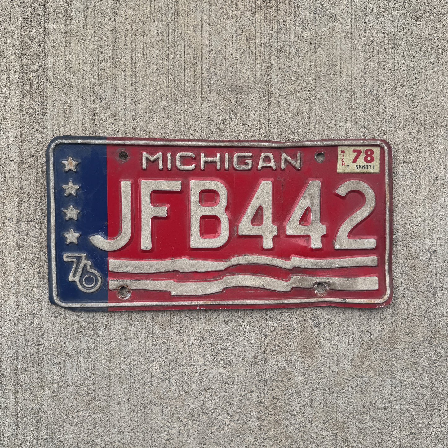 Photo of a 1976 1978 Michigan License Plate Auto Tag Garage Decor Vintage JFB 442 with original patina