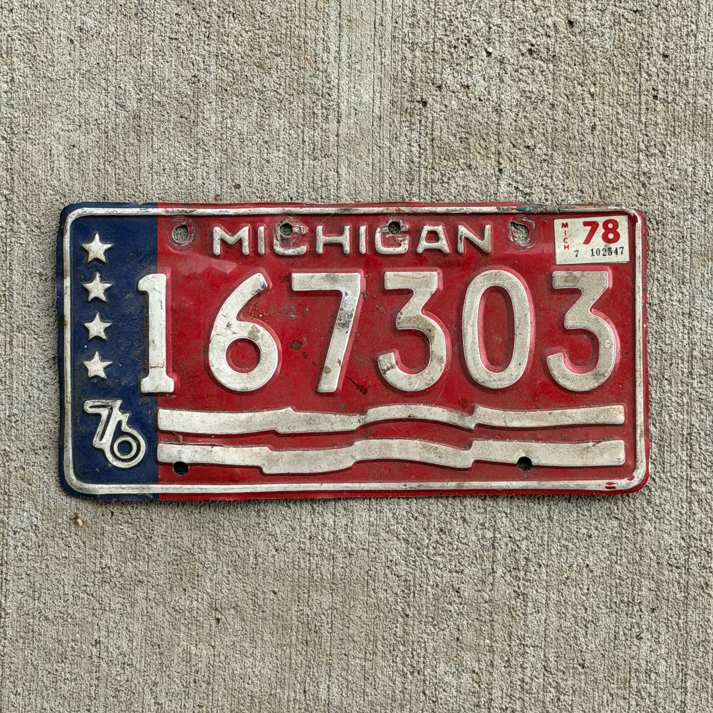 Photo of a 1976 1978 Michigan Trailer License Plate Auto Tag Garage Decor Vintage Bicentennial 167 303 with original patina
