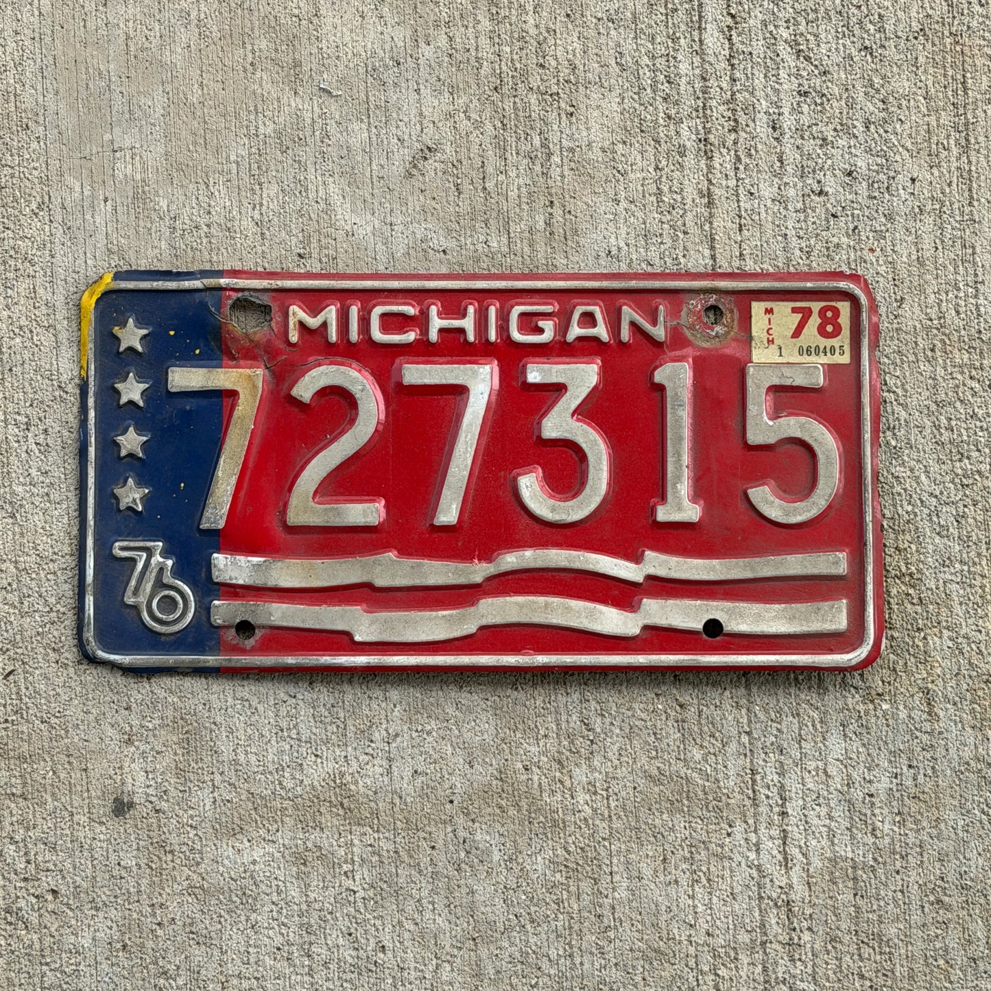 Photo of a 1976 1978 Michigan Trailer License Plate Auto Tag Garage Decor Vintage Bicentennial 727 315 with original patina