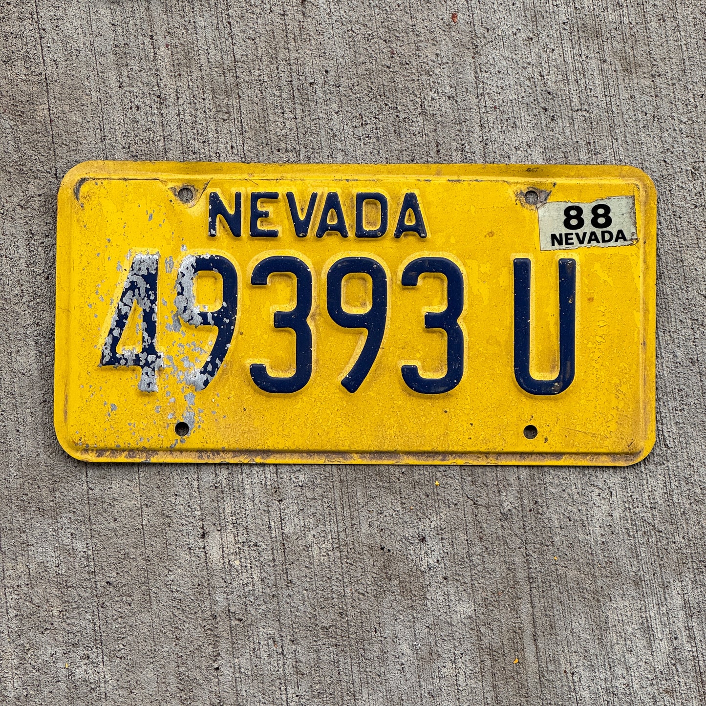 Photo of a 1976 1988 Nevada Truck Mileage Tax License Plate Auto Tag Garage Decor Vintage 49393 U with original patina