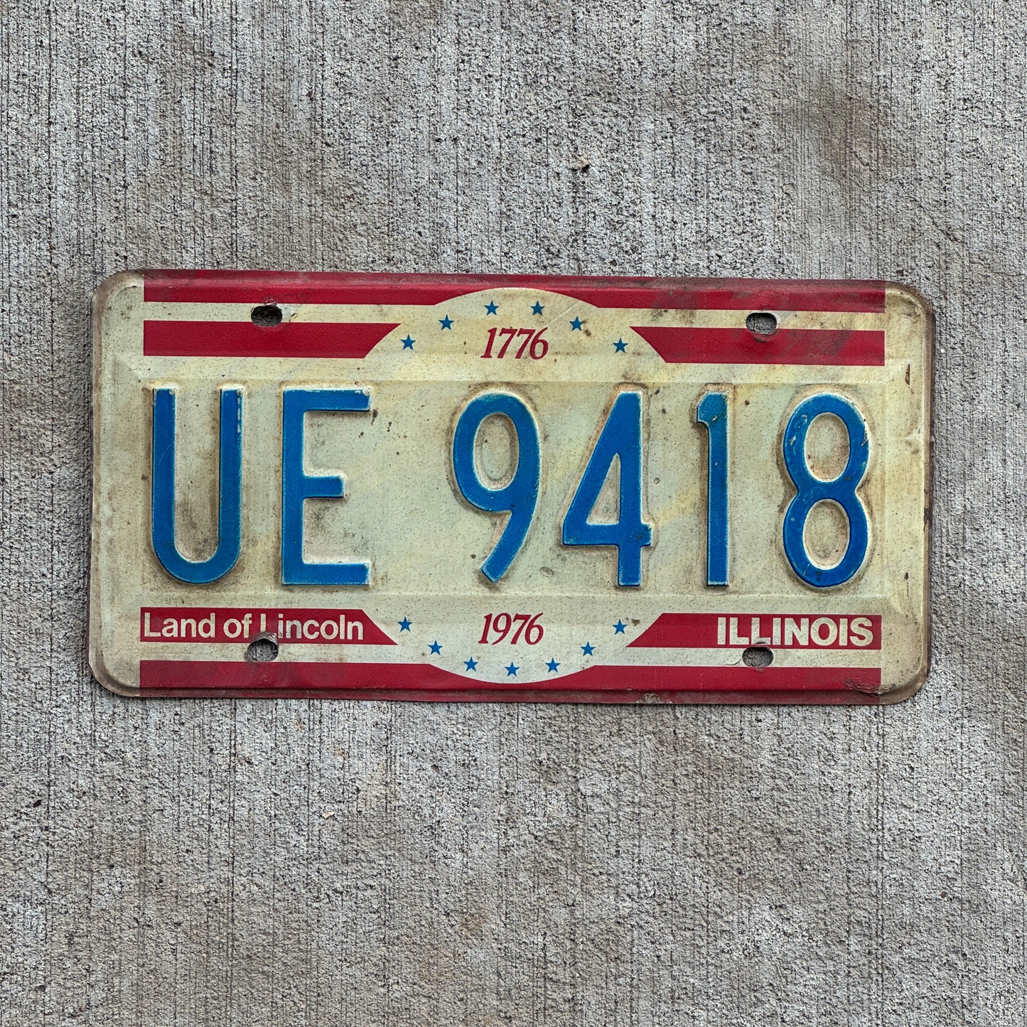 Photo of a 1976 Illinois License Plate Auto Tag 1 Vintage Garage Bicentennial UE 9418 with original patina