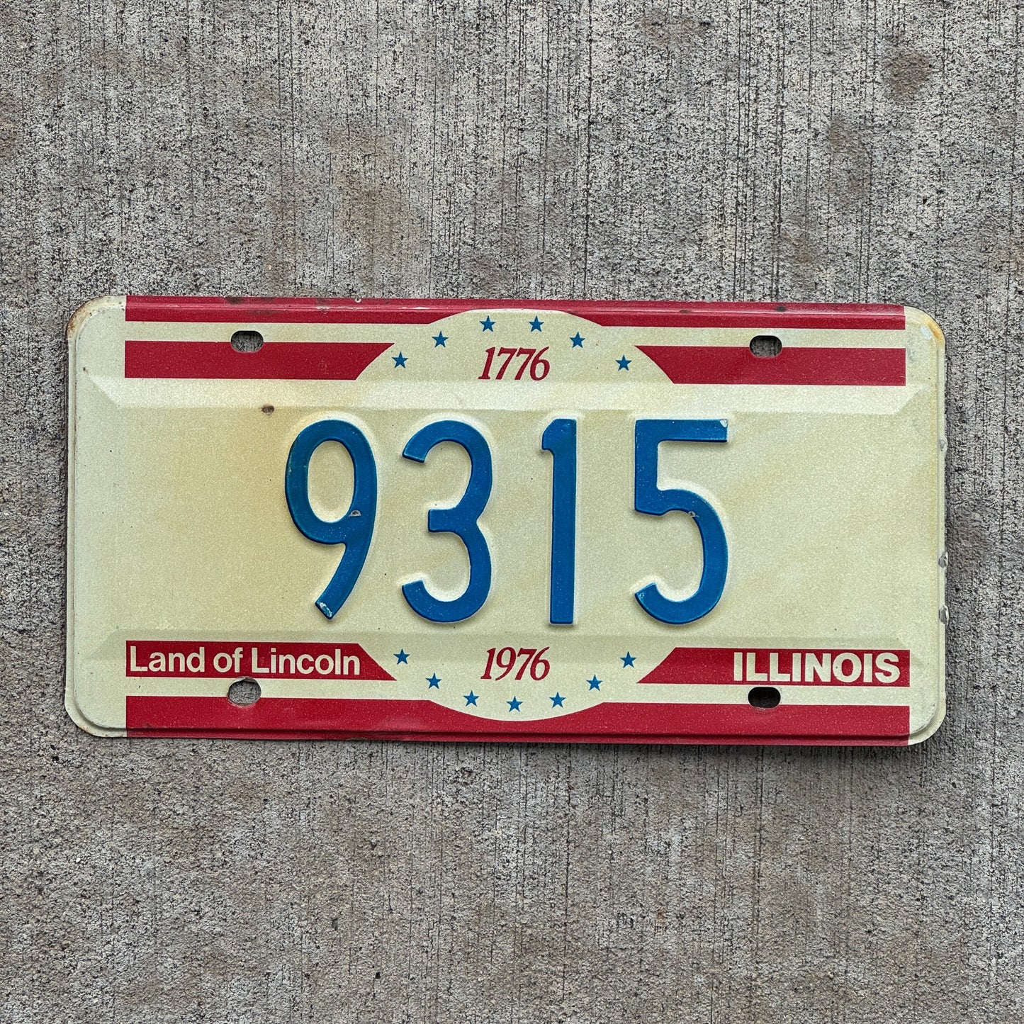 Photo of a 1976 Illinois License Plate Auto Tag Garage Decor Vintage Low Number Four Digit 9315 with original patina