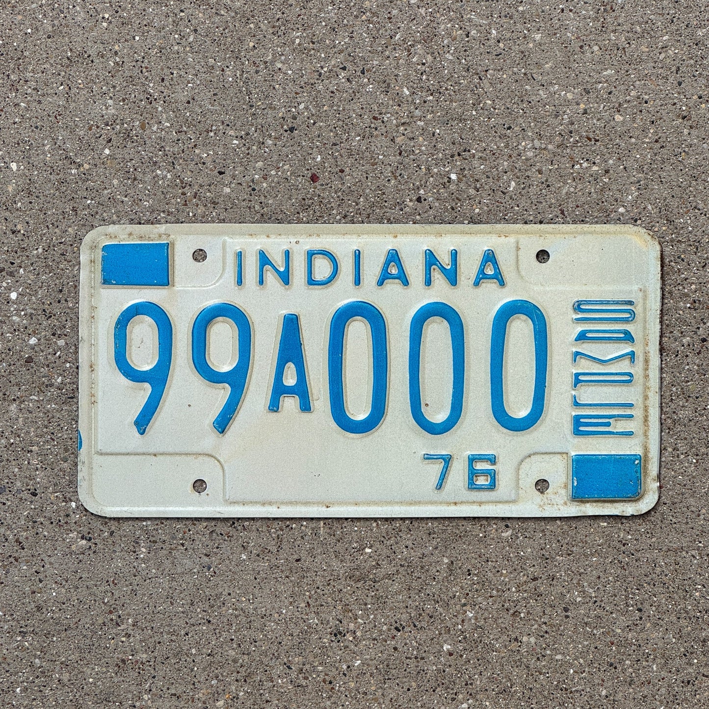 Photo of a 1976 Indiana Sample License Plate Auto Tag 3 Vintage 99A000 with original patina