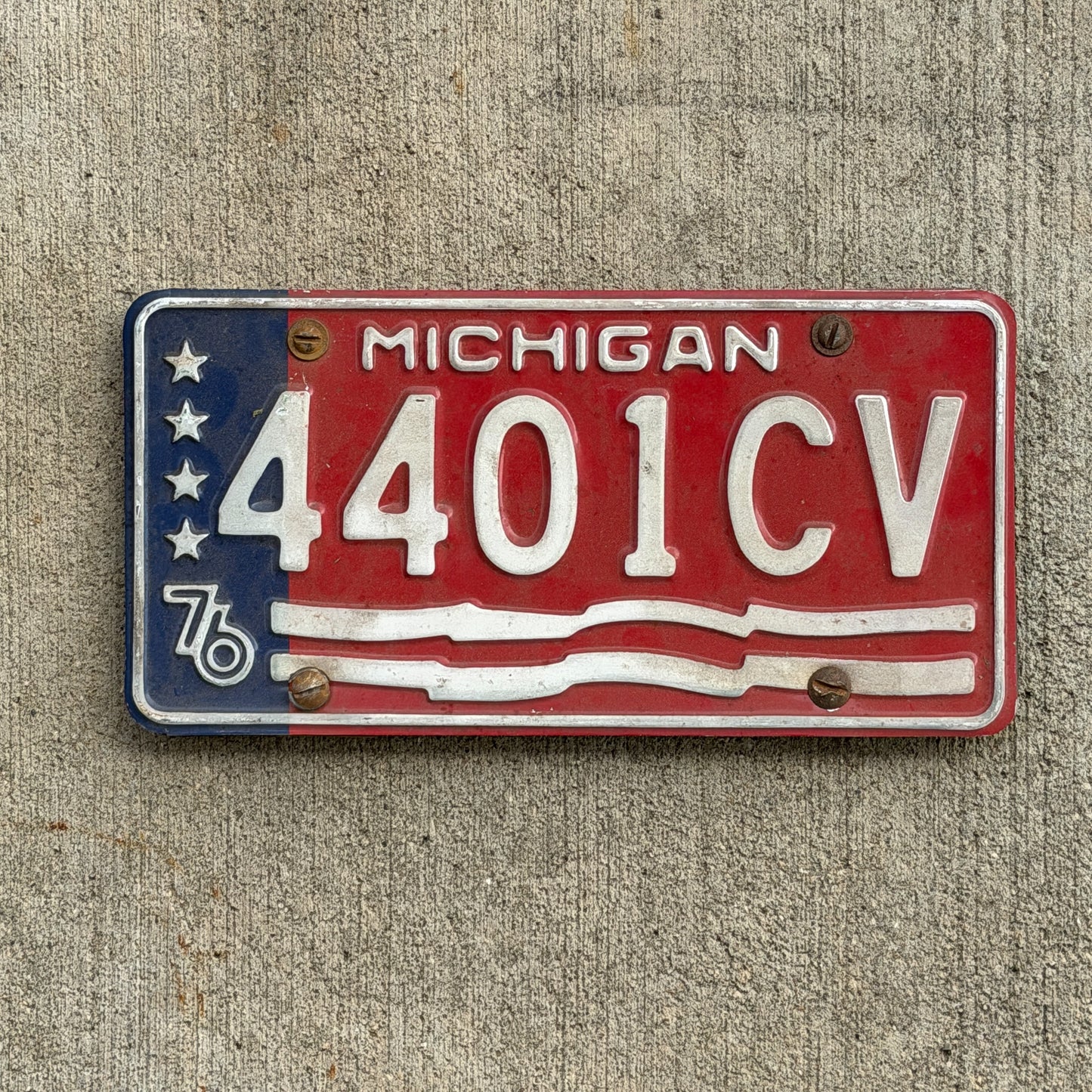 Photo of a 1976 Michigan Commercial License Plate Auto Tag Garage Decor Vintage Bicentennial 4401 CV with original patina