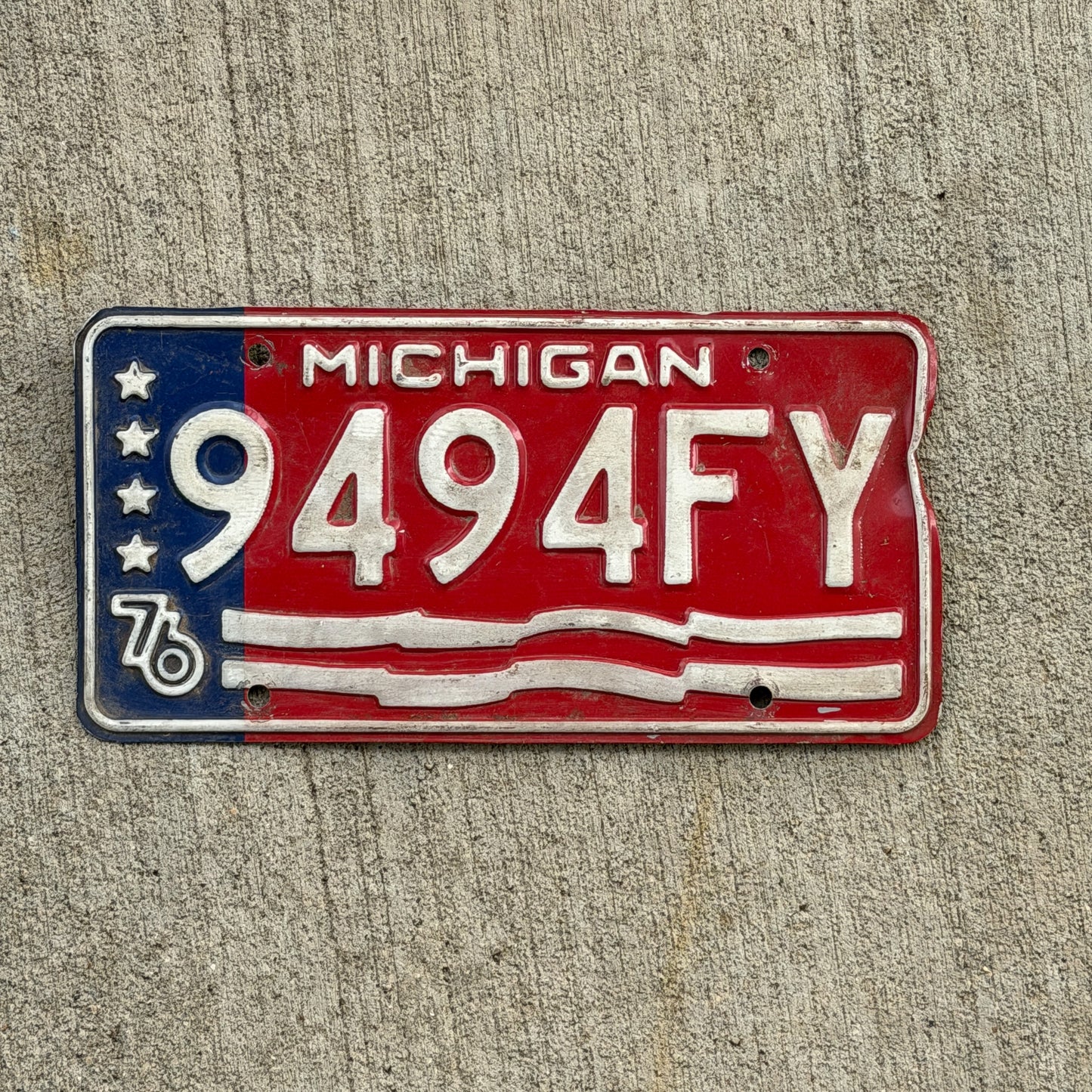 Photo of a 1976 Michigan Commercial License Plate Auto Tag Garage Decor Vintage Bicentennial 9494 FY with original patina