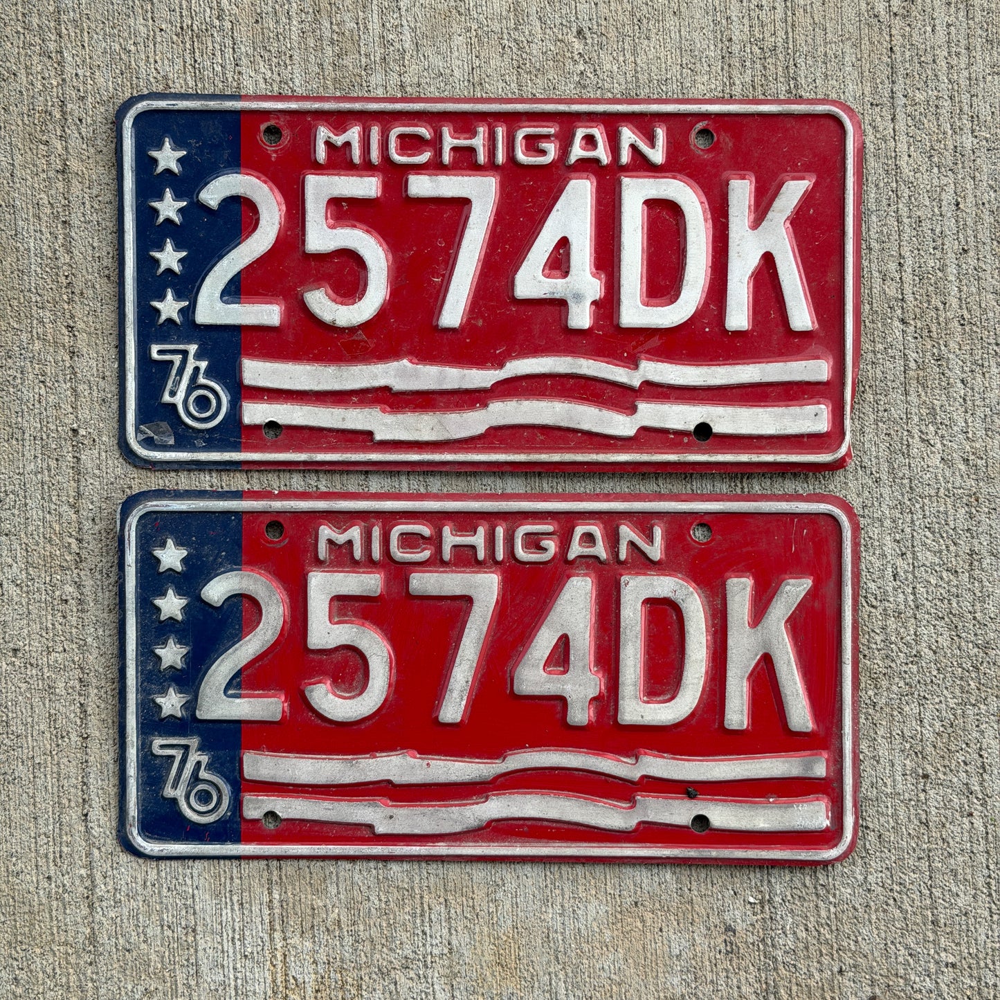 Photo of a 1976 Michigan Commercial License Plate Pair Auto Tag Garage Decor Vintage Bicentennial 2574 DK with original patina