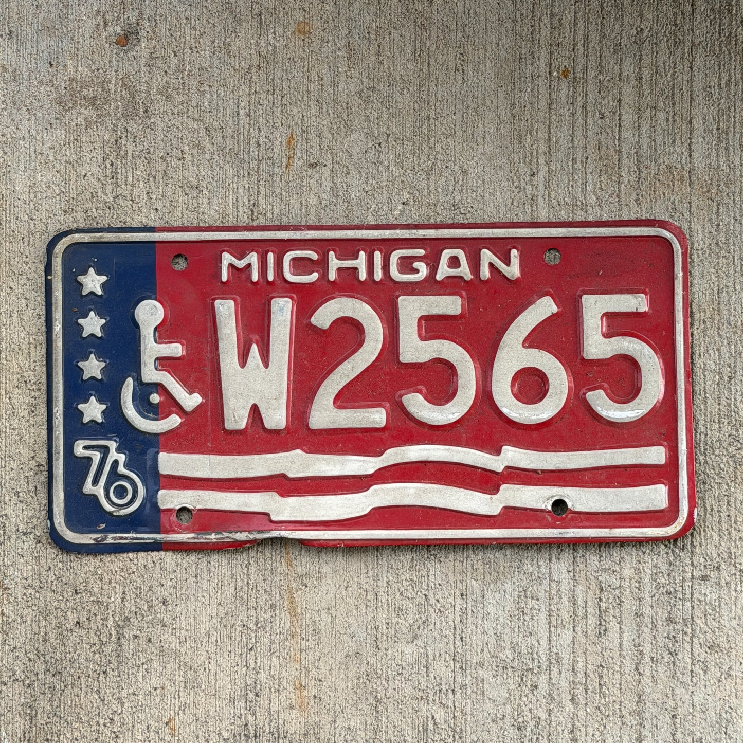 Photo of a 1976 Michigan Handicap License Plate Auto Tag Garage Decor Vintage Bicentennial W 2565 with original patina