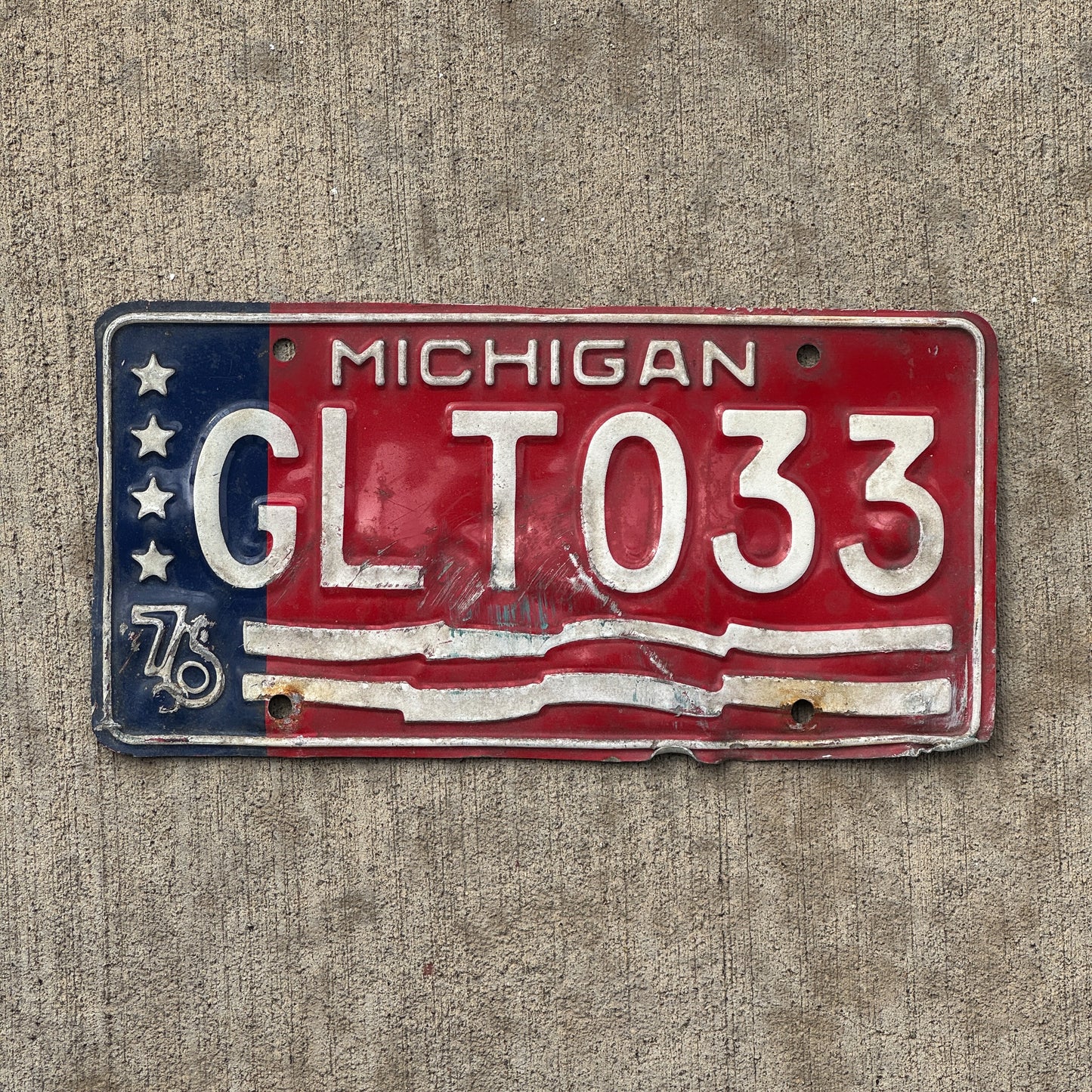 Photo of a 1976 Michigan License Plate Auto Tag Garage Decor Vintage American Flag Bicentennial GLT 033 with original patina
